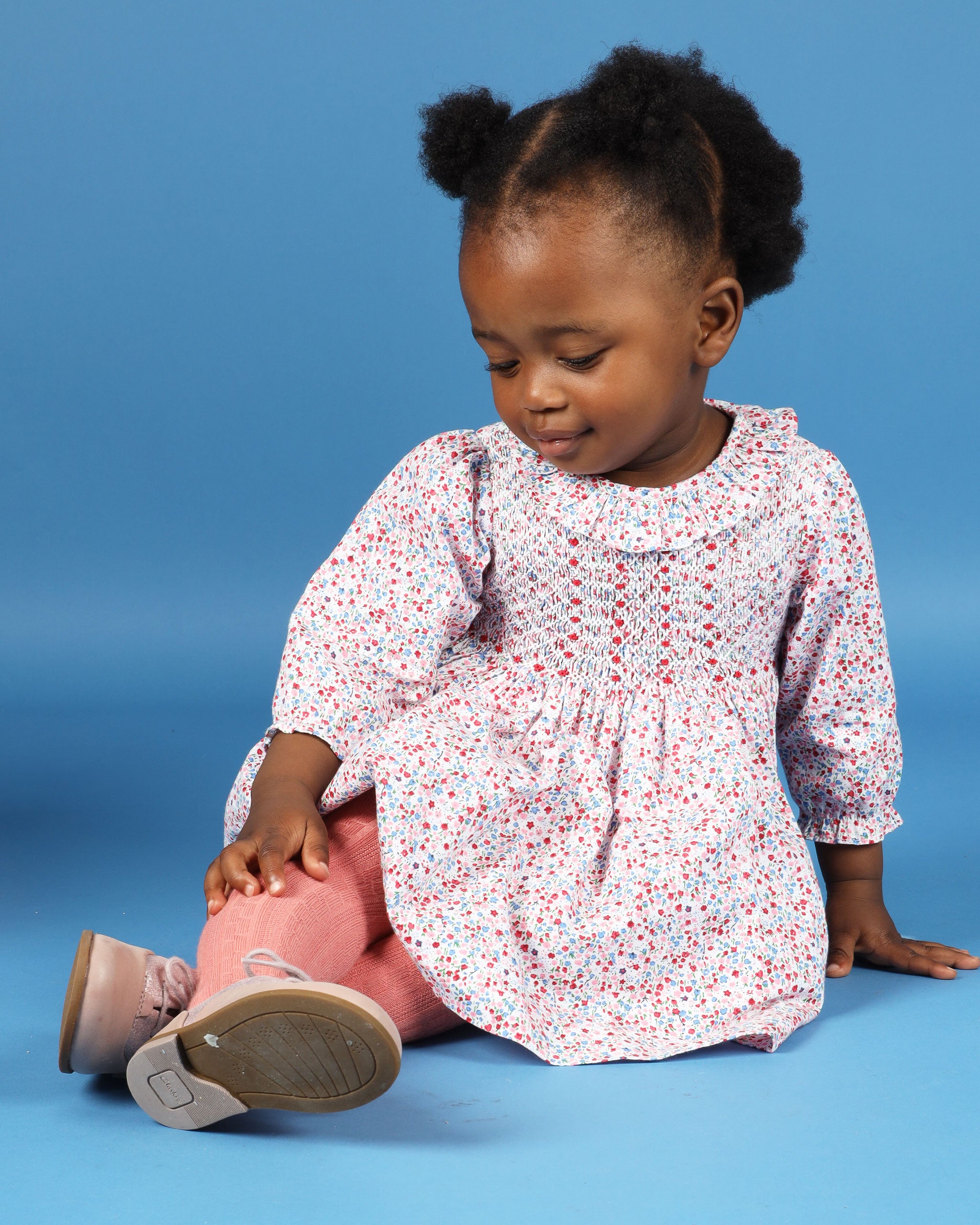 baby girl in pink floral smock dress