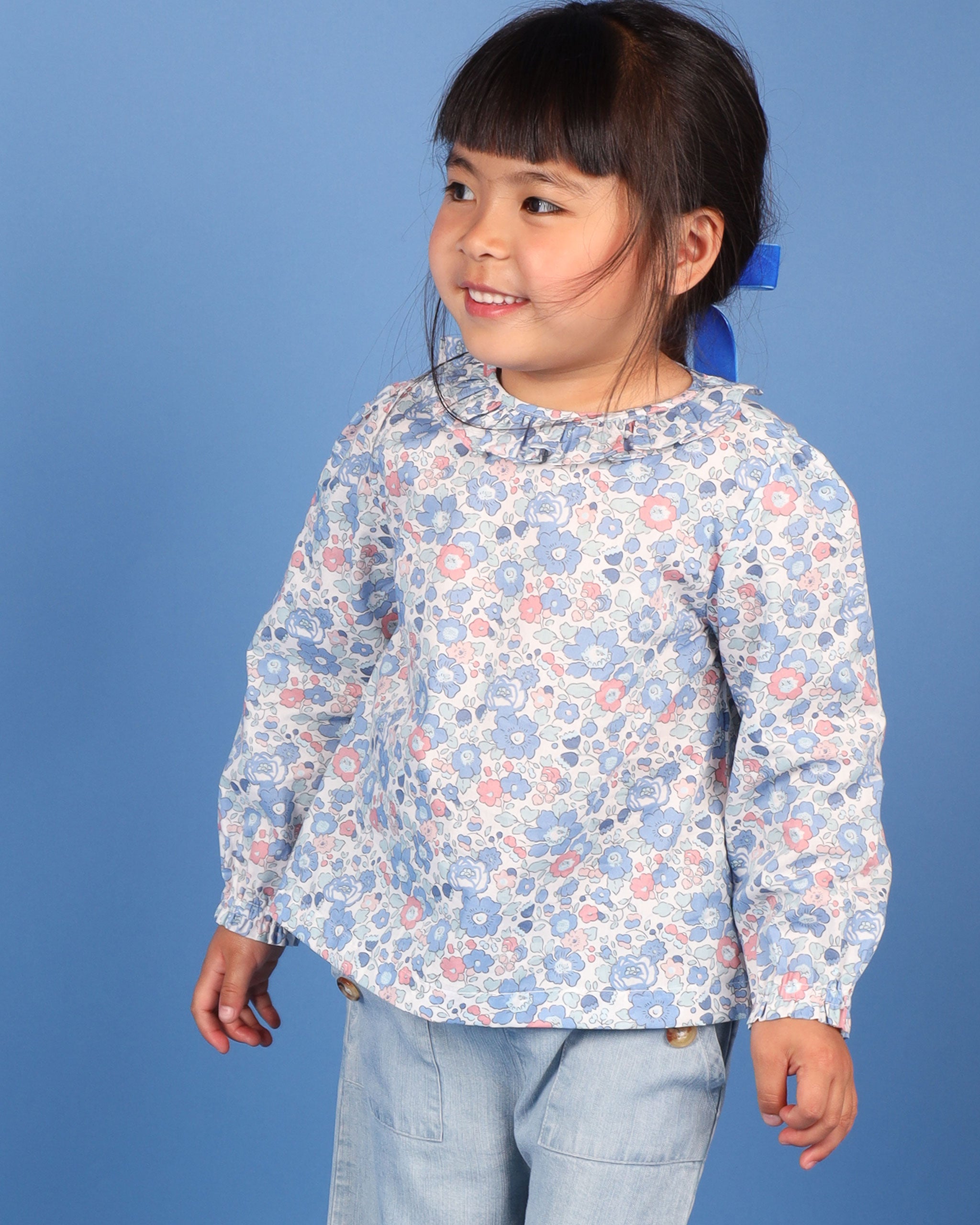 girl in floral blouse made with Liberty fabric