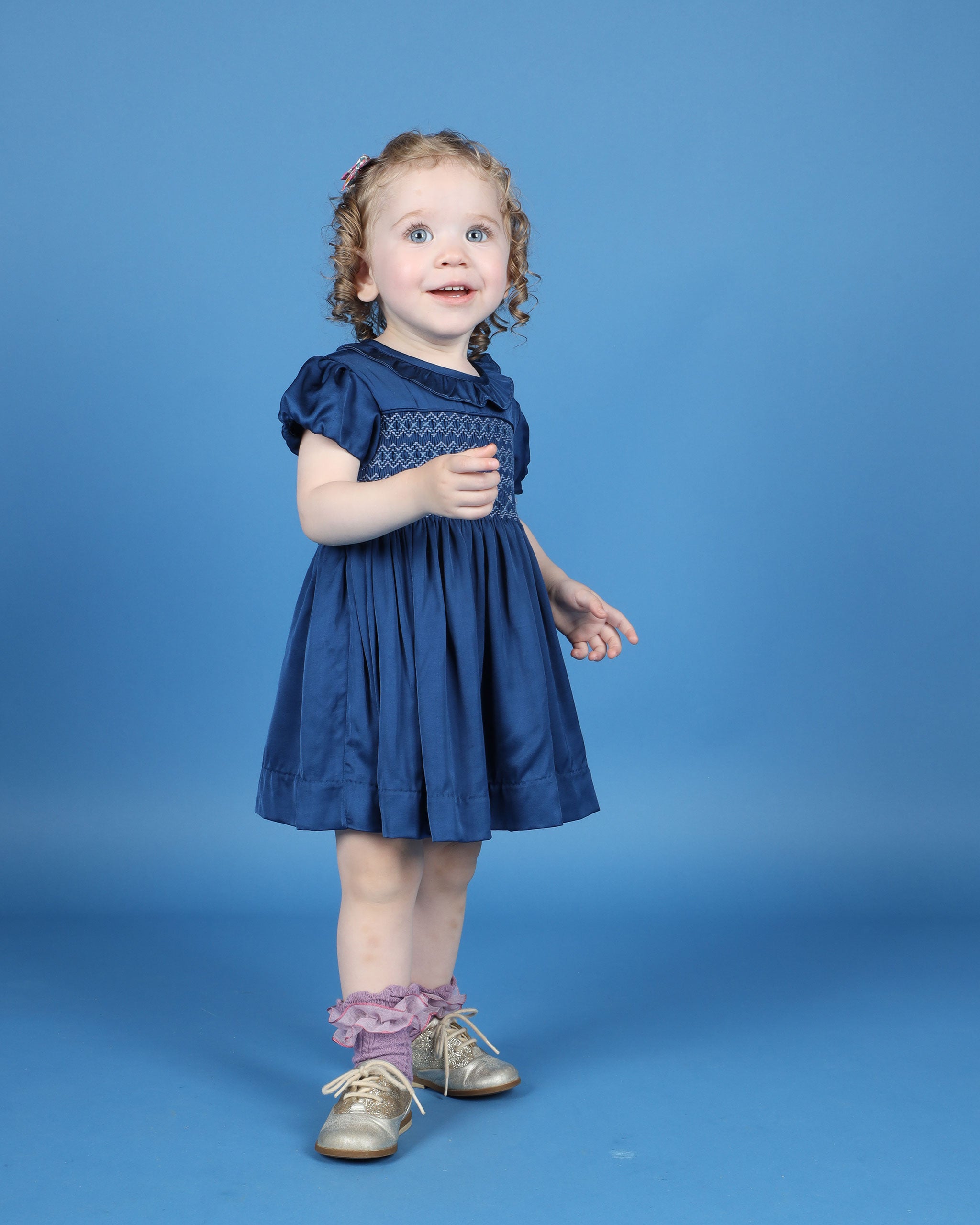 Hand-smocked navy satin party dress with bloomers and frill collar
