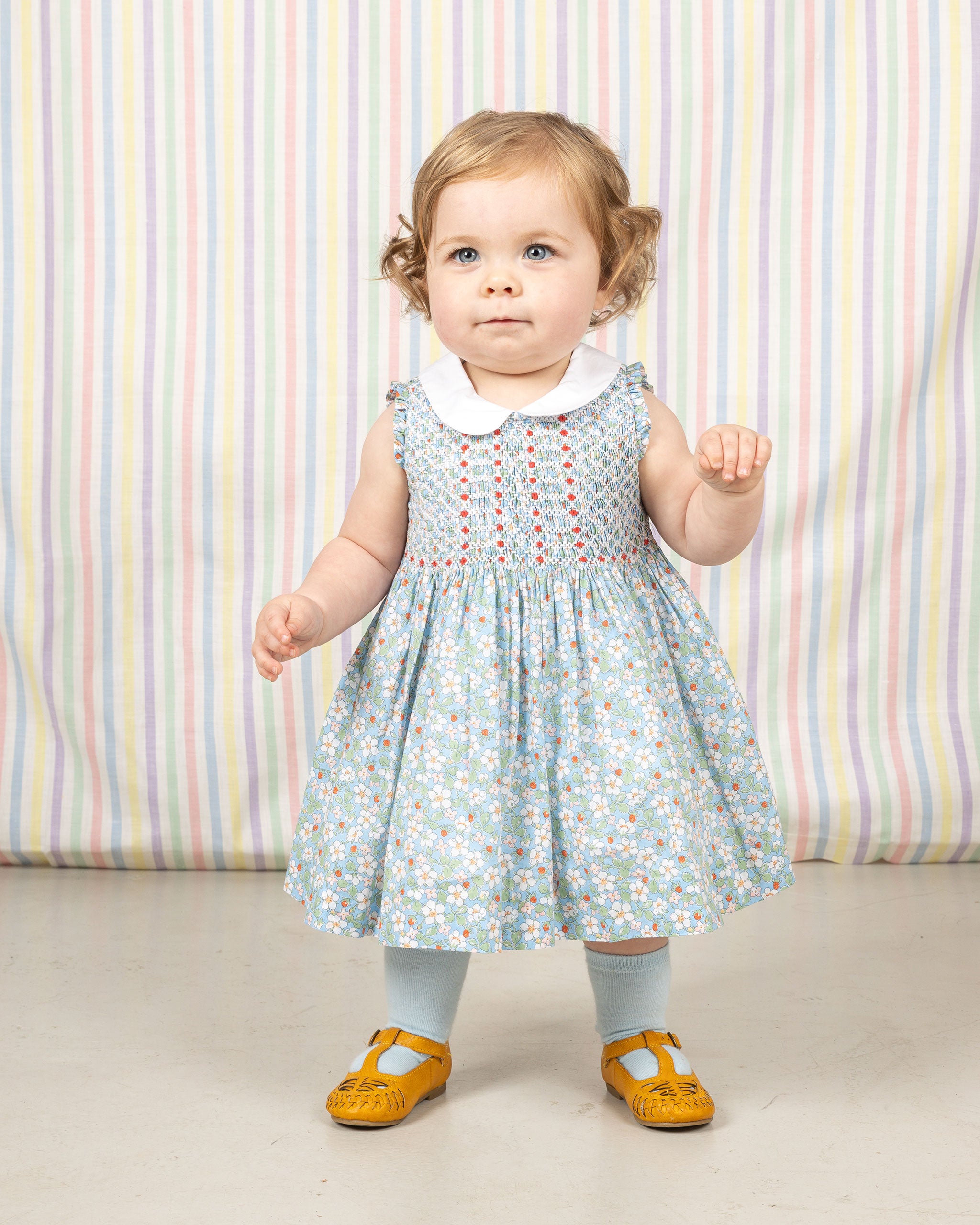 baby girl in Liberty fabric smocked dress