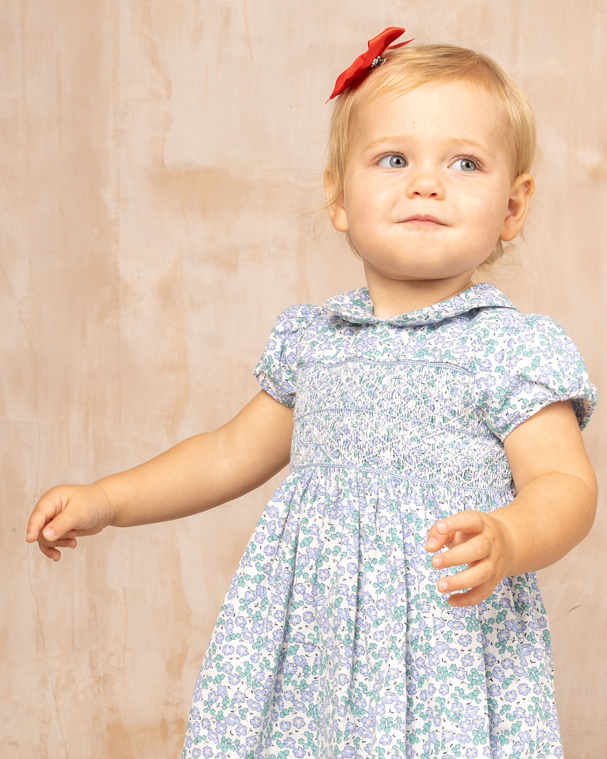 baby in smock dress, lilac blossom