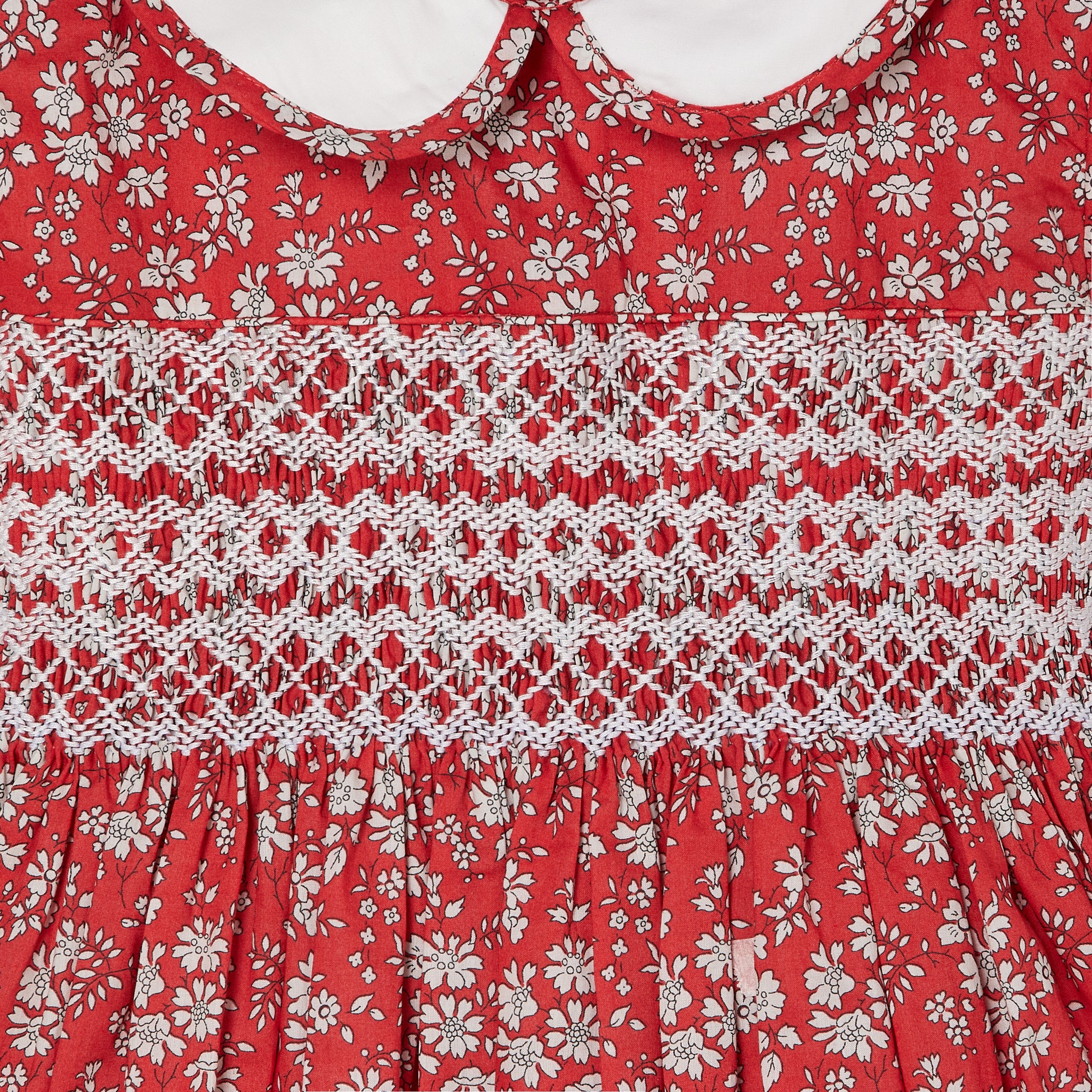 red and white floral dress made form Liberty Fabric, smocking detail
