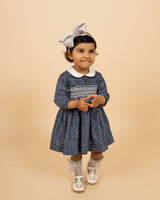toddler in hand-smocked dress with white collar