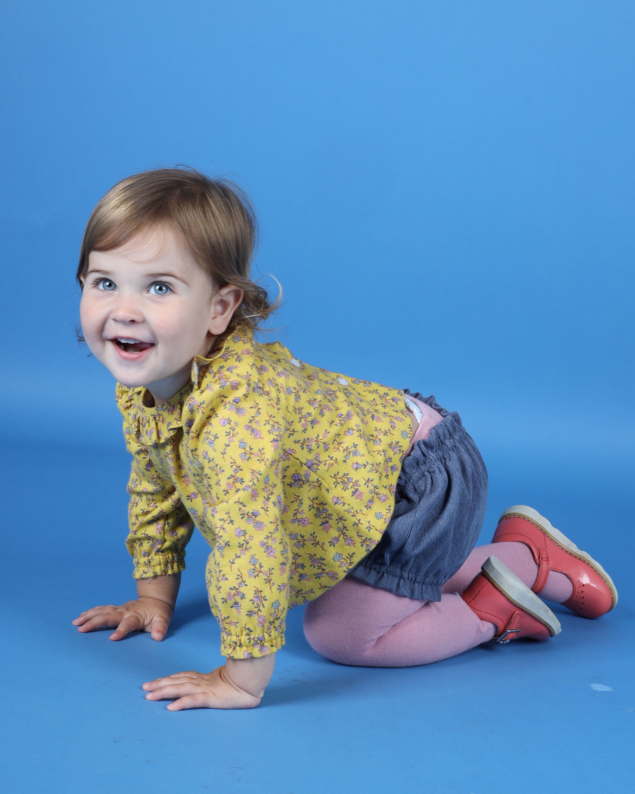 happy baby in frill blouse
