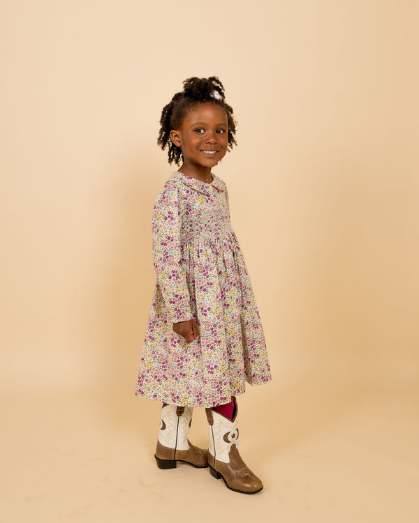 girl model in smocked dress and cowboy boots