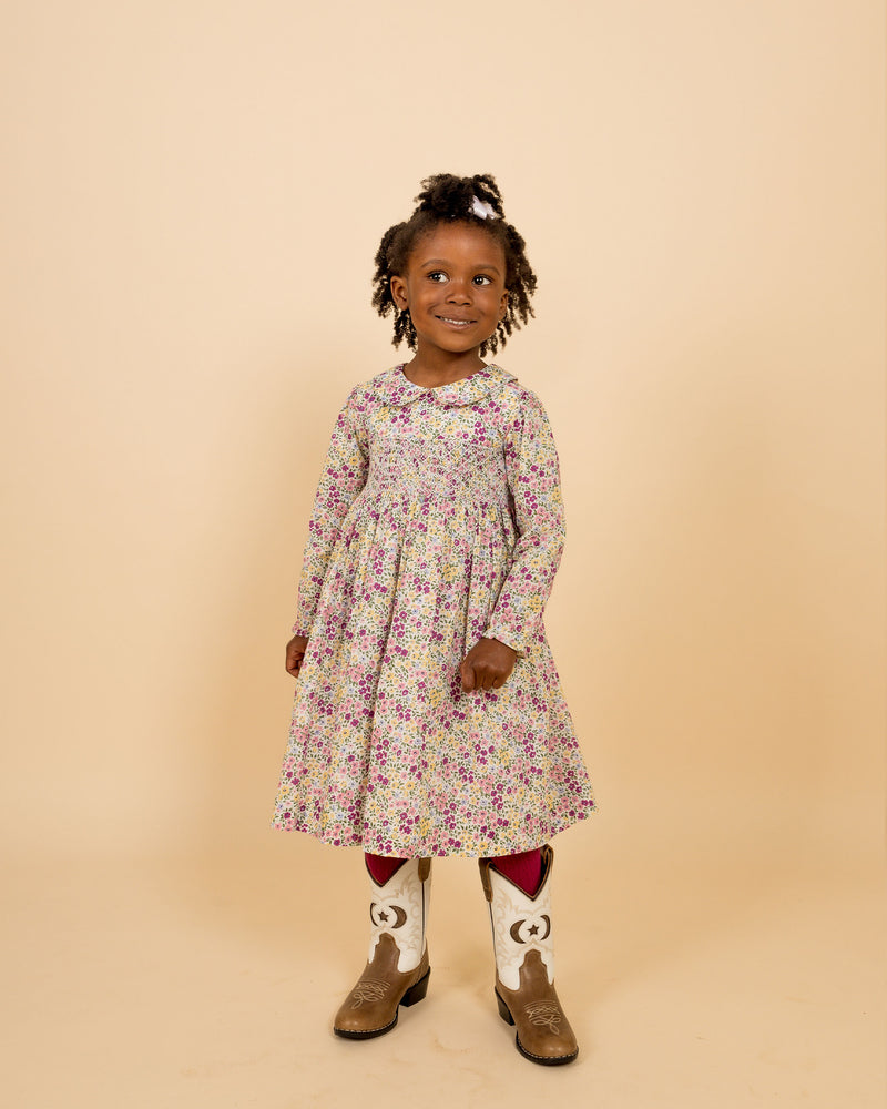 child wearing floral smock dress