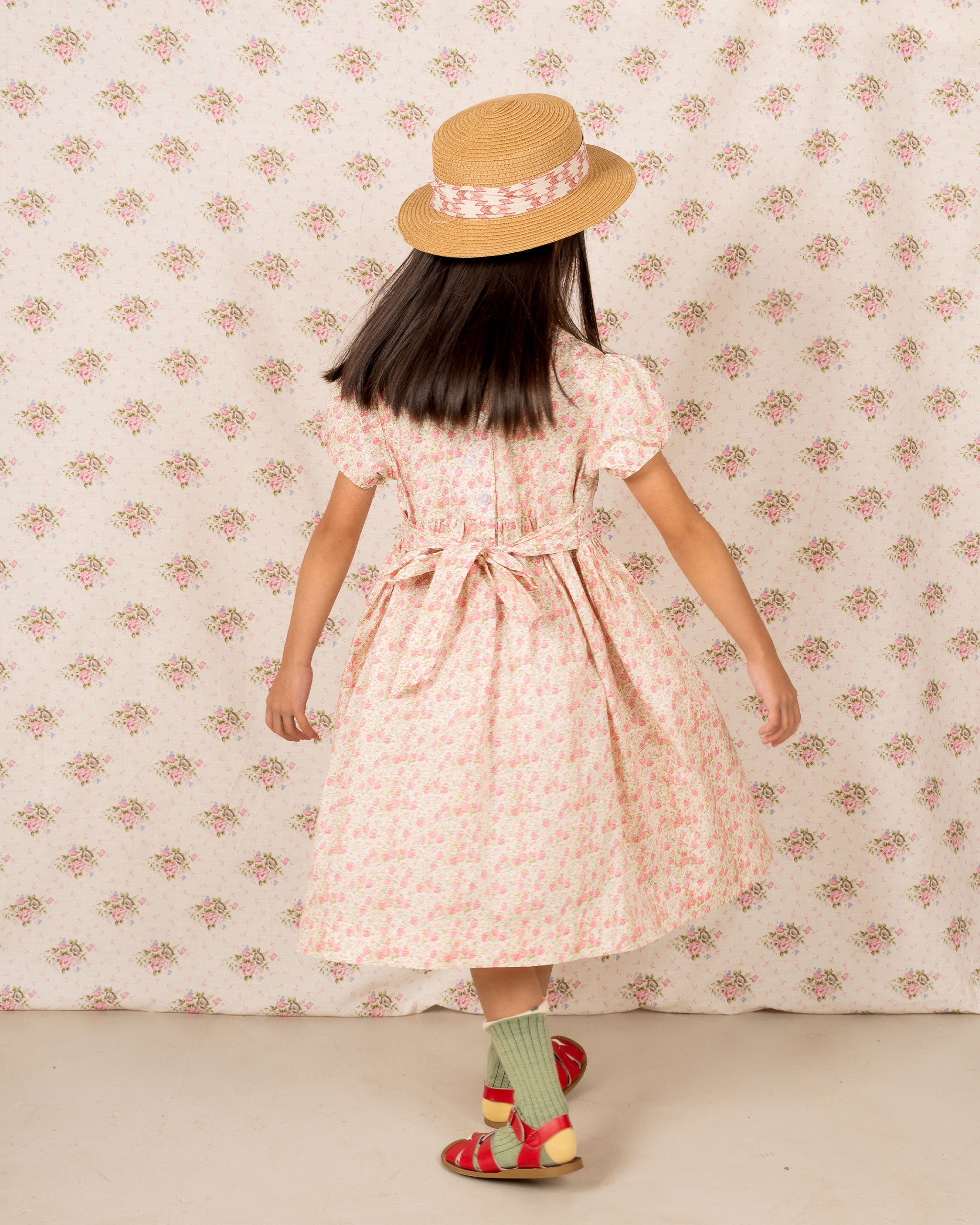pastel strawberry dress, hand-smocked, back view on model