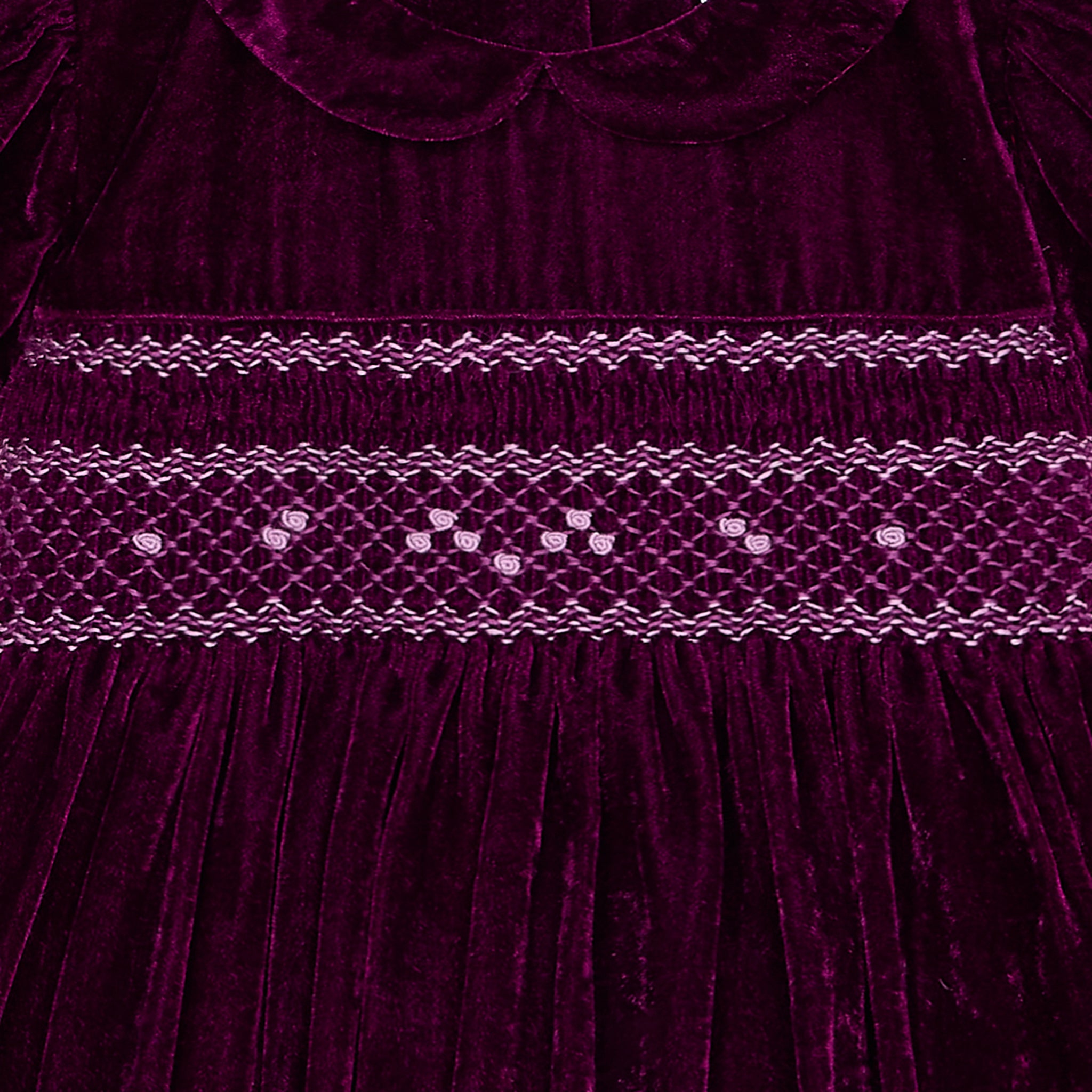 Close-up of smocking and embroidery on velvet dress