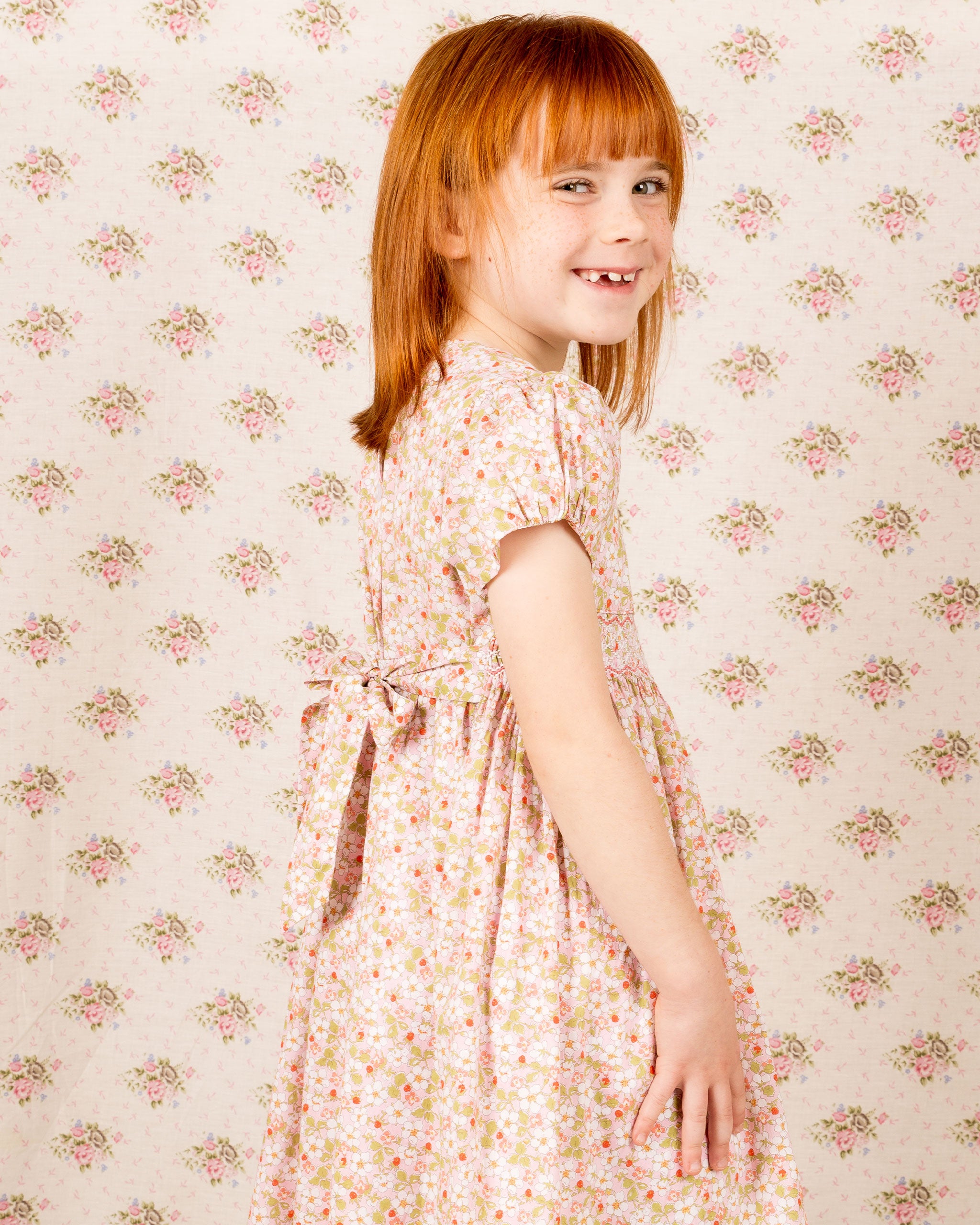 girl wearings Liberty strawberry print dress