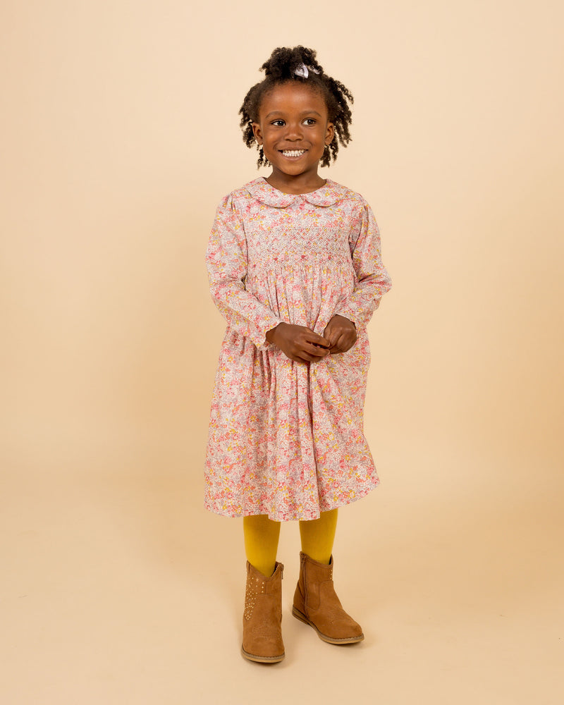 girl in Liberty fabric dress, pink and yellow floral print, hand-smocked