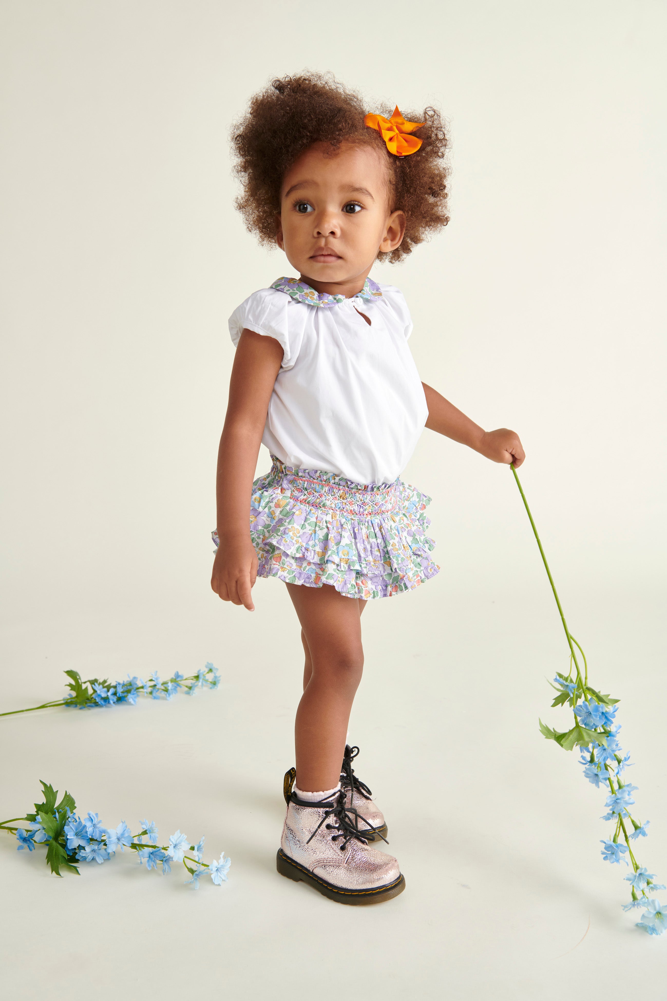 toddler in matching skort and blouse 
