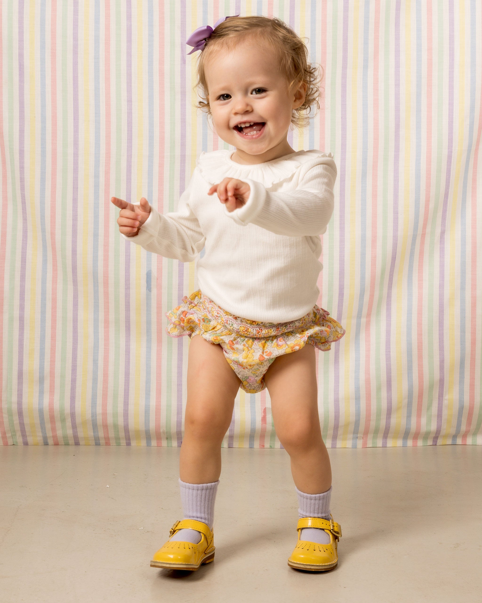 baby wearing  bloomers, yellow, floral