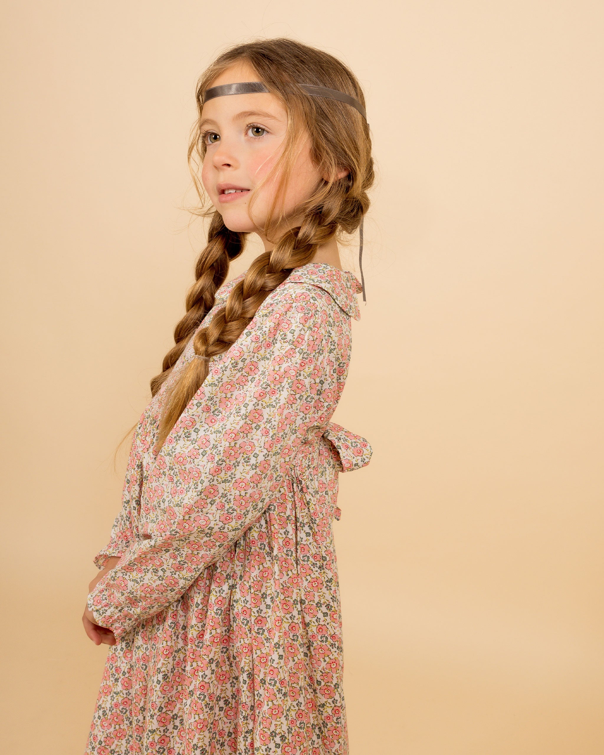 girl in floral, pink smocked dress
