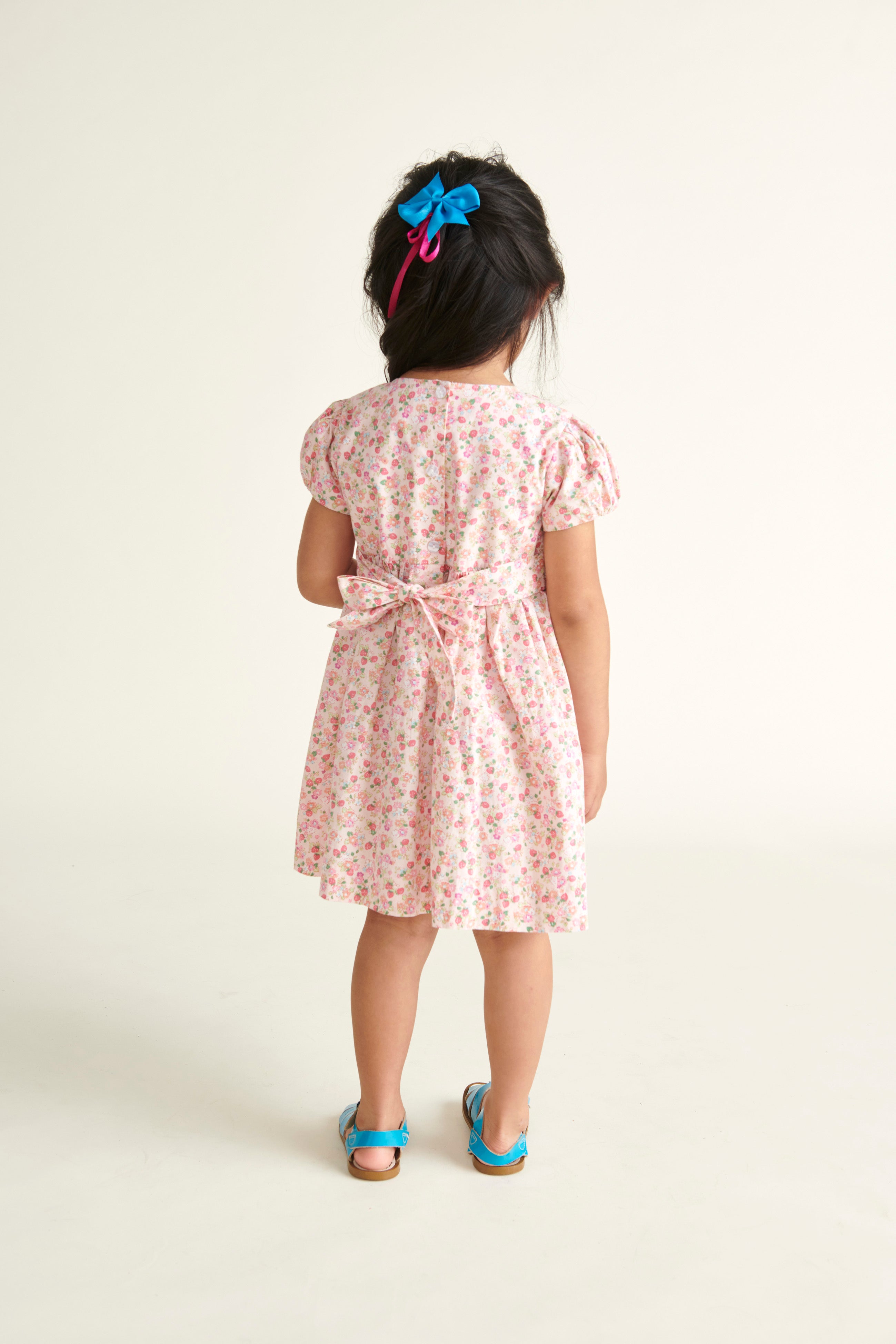 girl in smocked dress  with bow at back