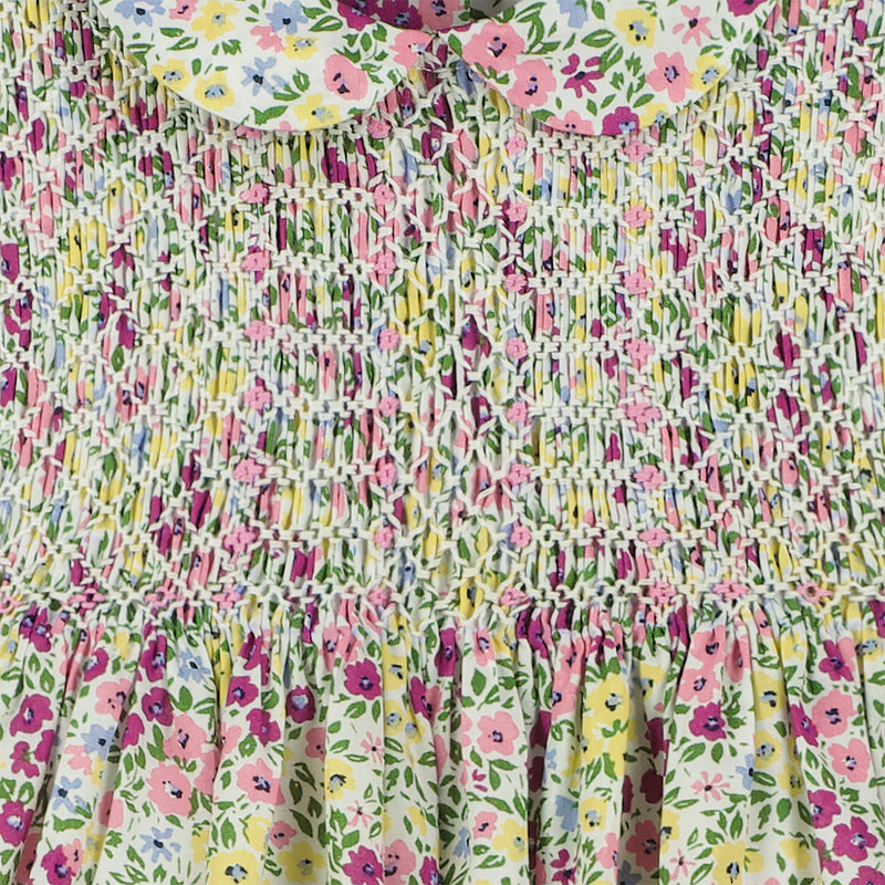 hand-smocked, floral baby dress, purple, pink and yellow blossoms, closeup of smocking