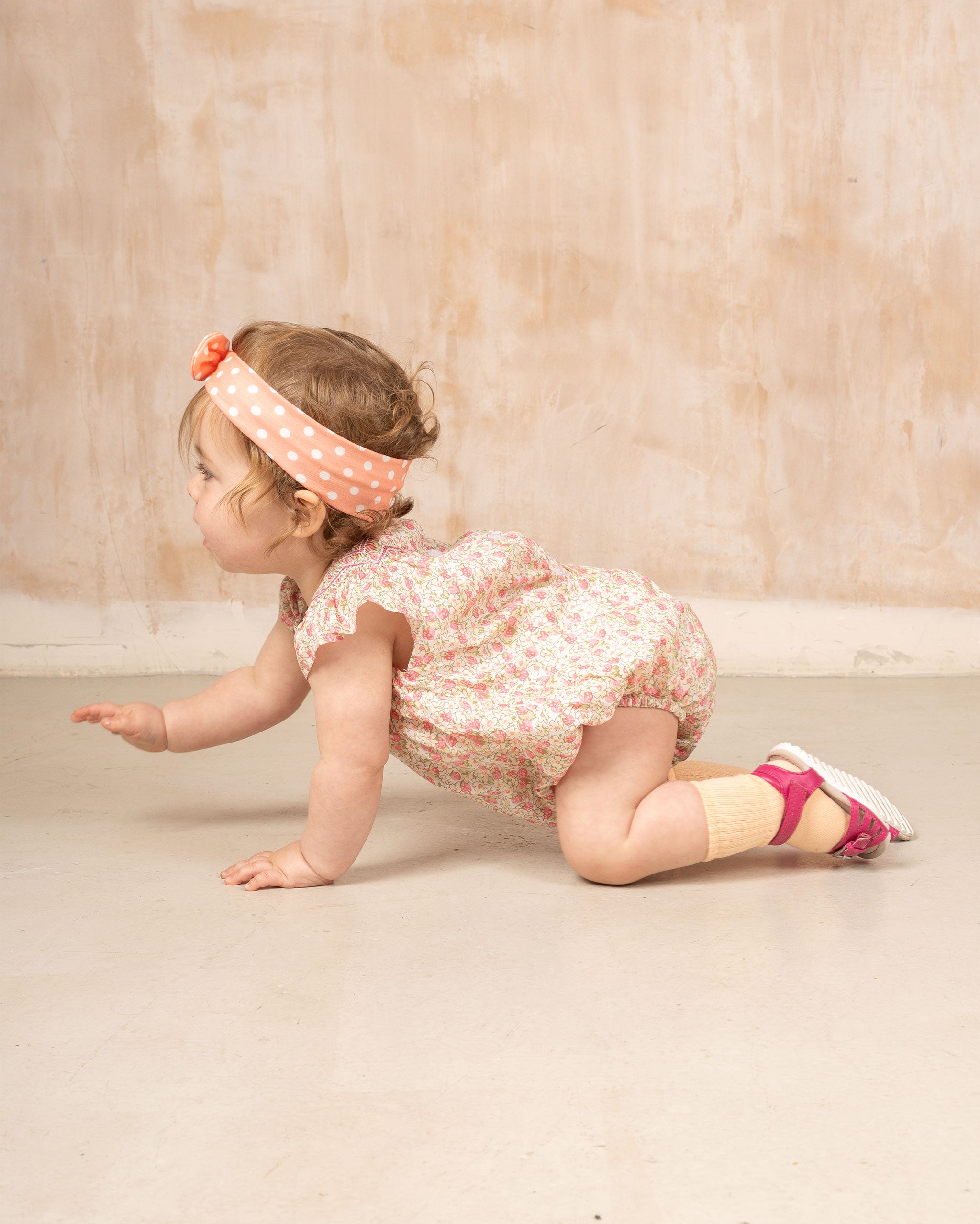 baby crawling in romper