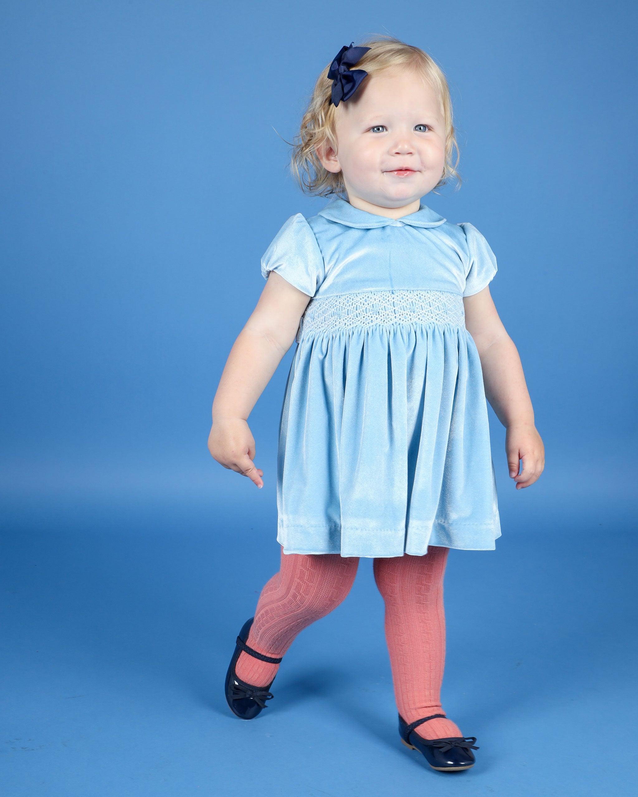 toddler in smocked velvet dress