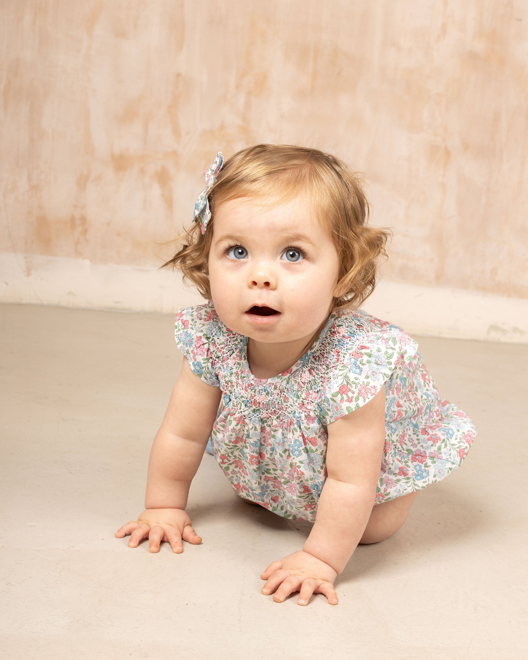 crawling baby in Liberty print romper