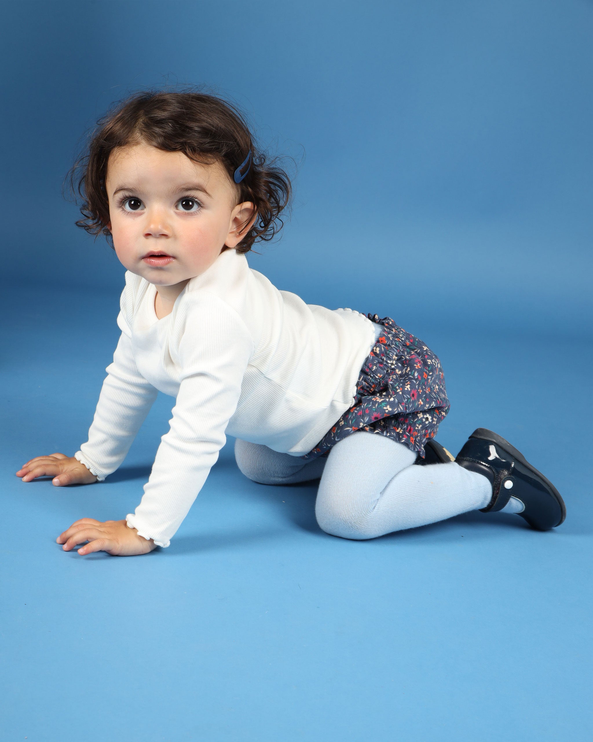 baby crawling in floral shorts