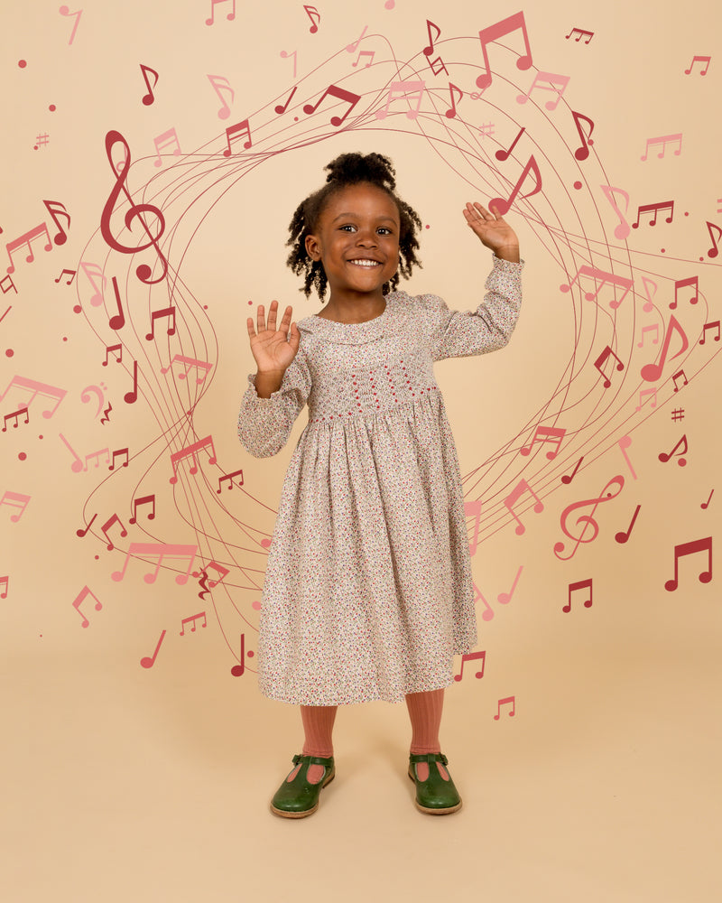girl in smock dress, musical note background