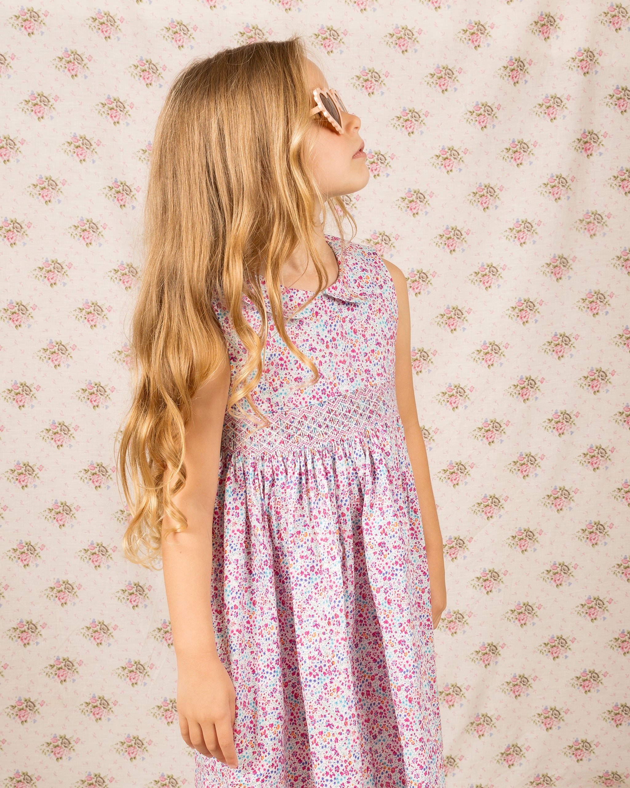 closeup of girl in summer smocked dress, floral