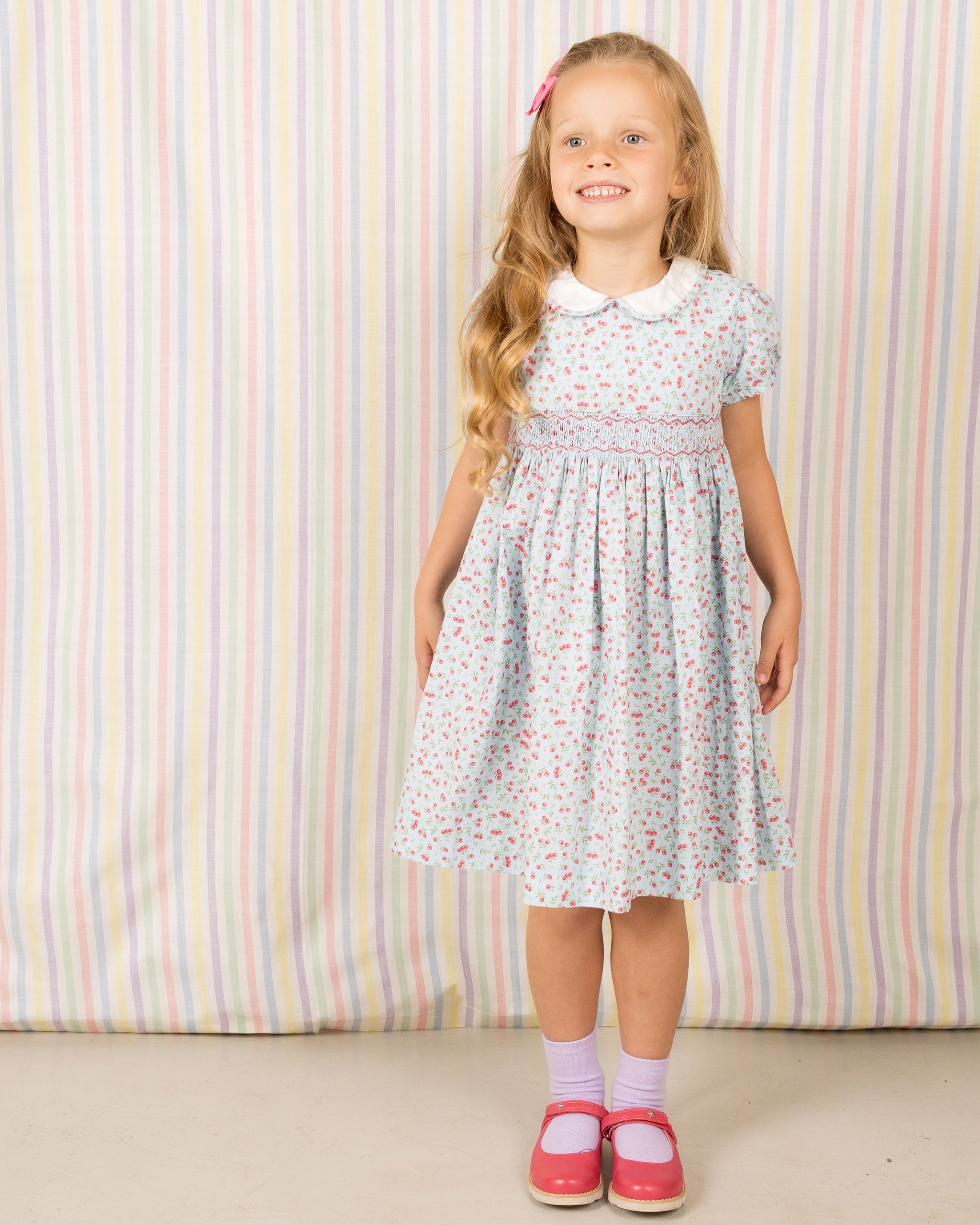 girl in smocked dress, cherry print and white collar