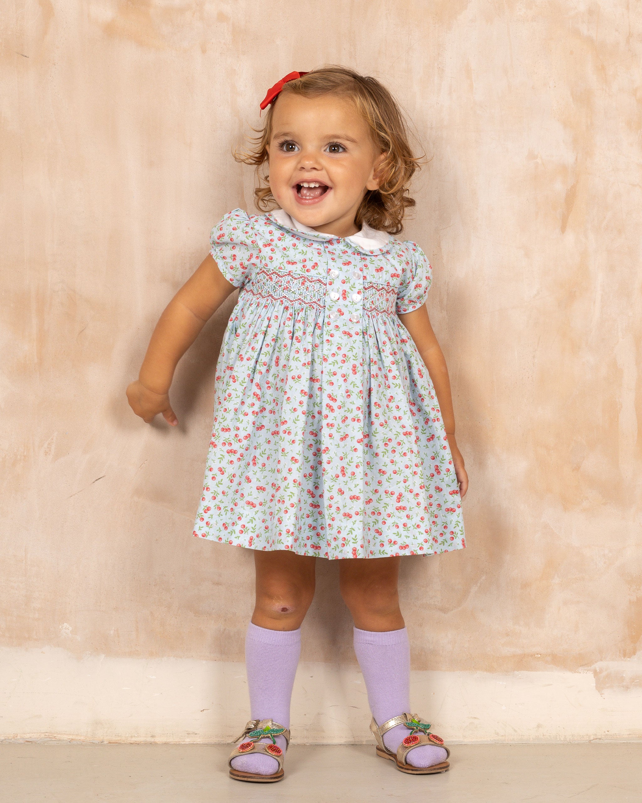 toddler in hand-smocked cherry print dress