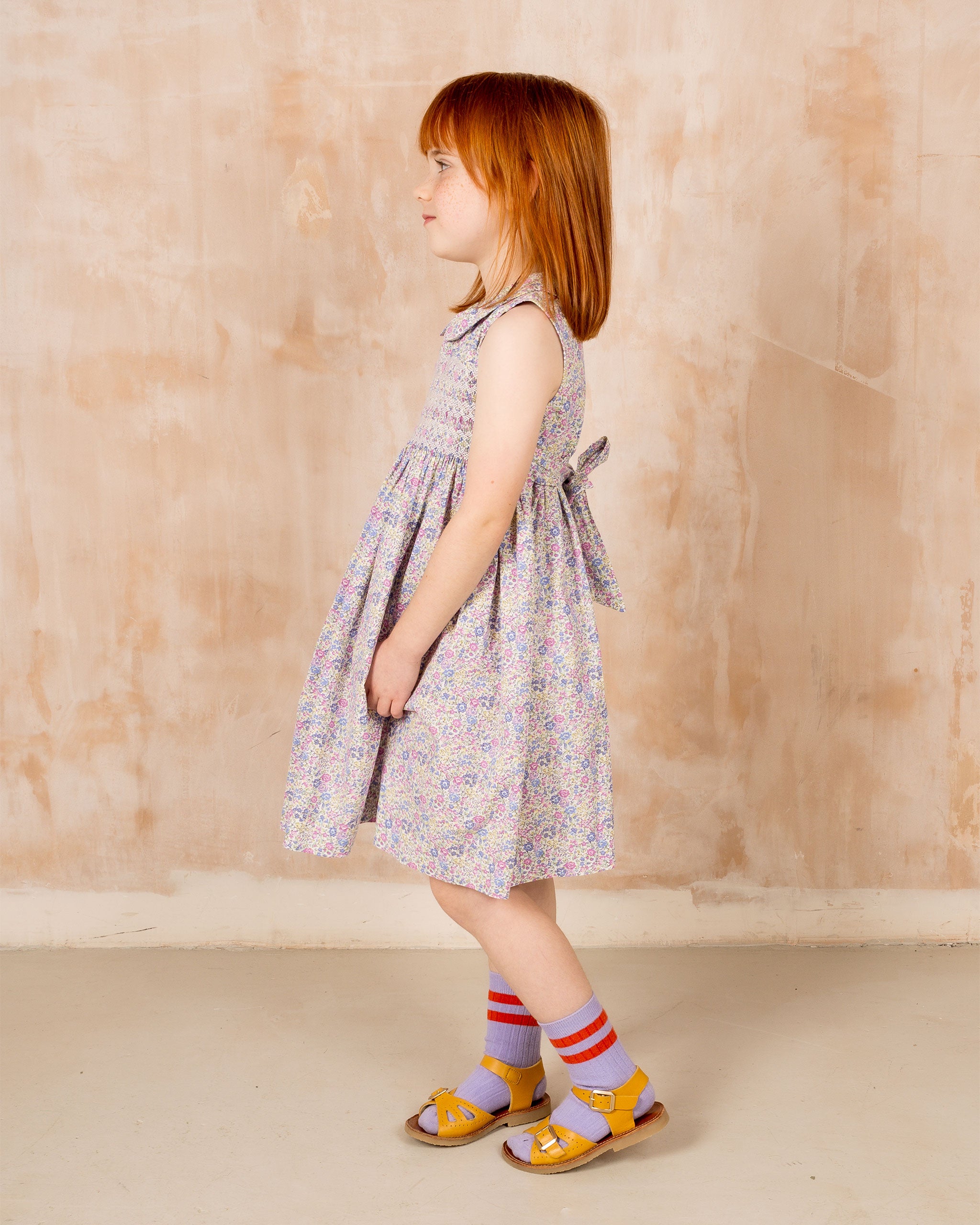girl in purple and lilac smock dress