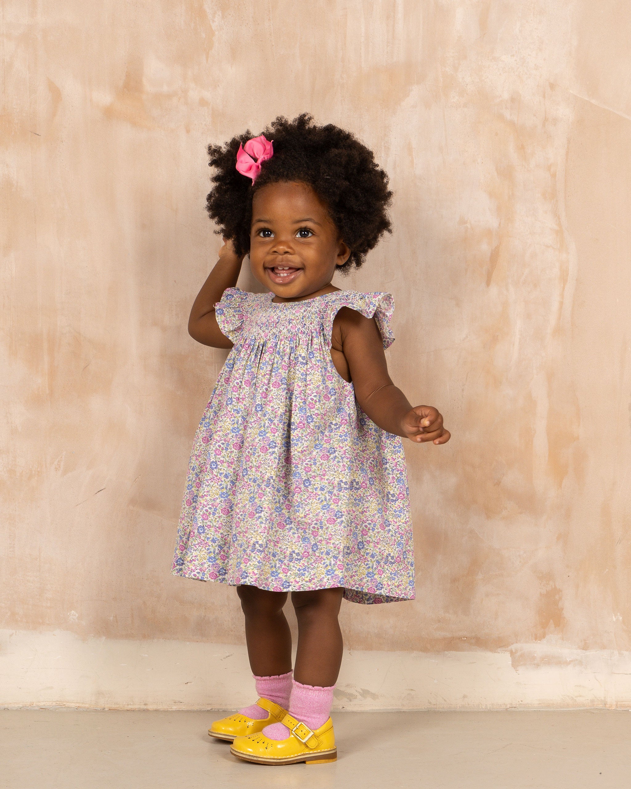 toddler in smocked frill sleeve floral dress