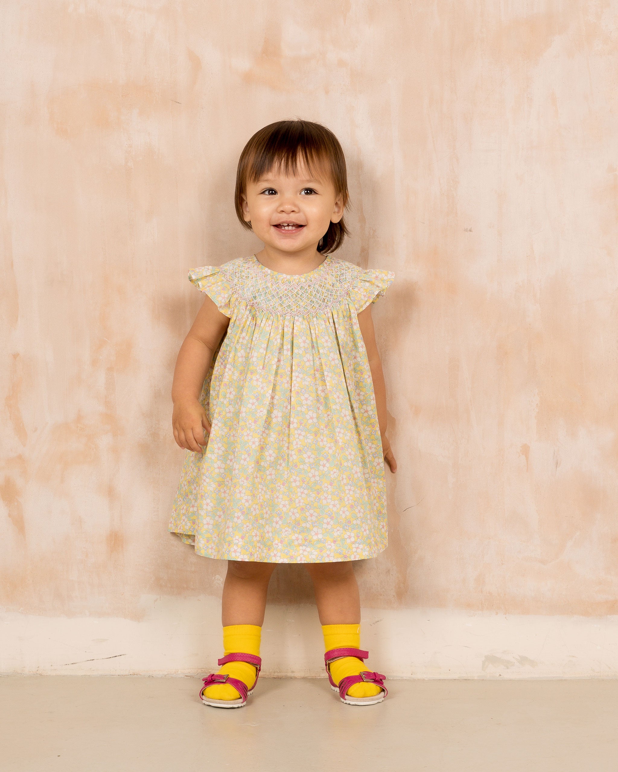 toddler in Liberty print dress with hand-smocking 