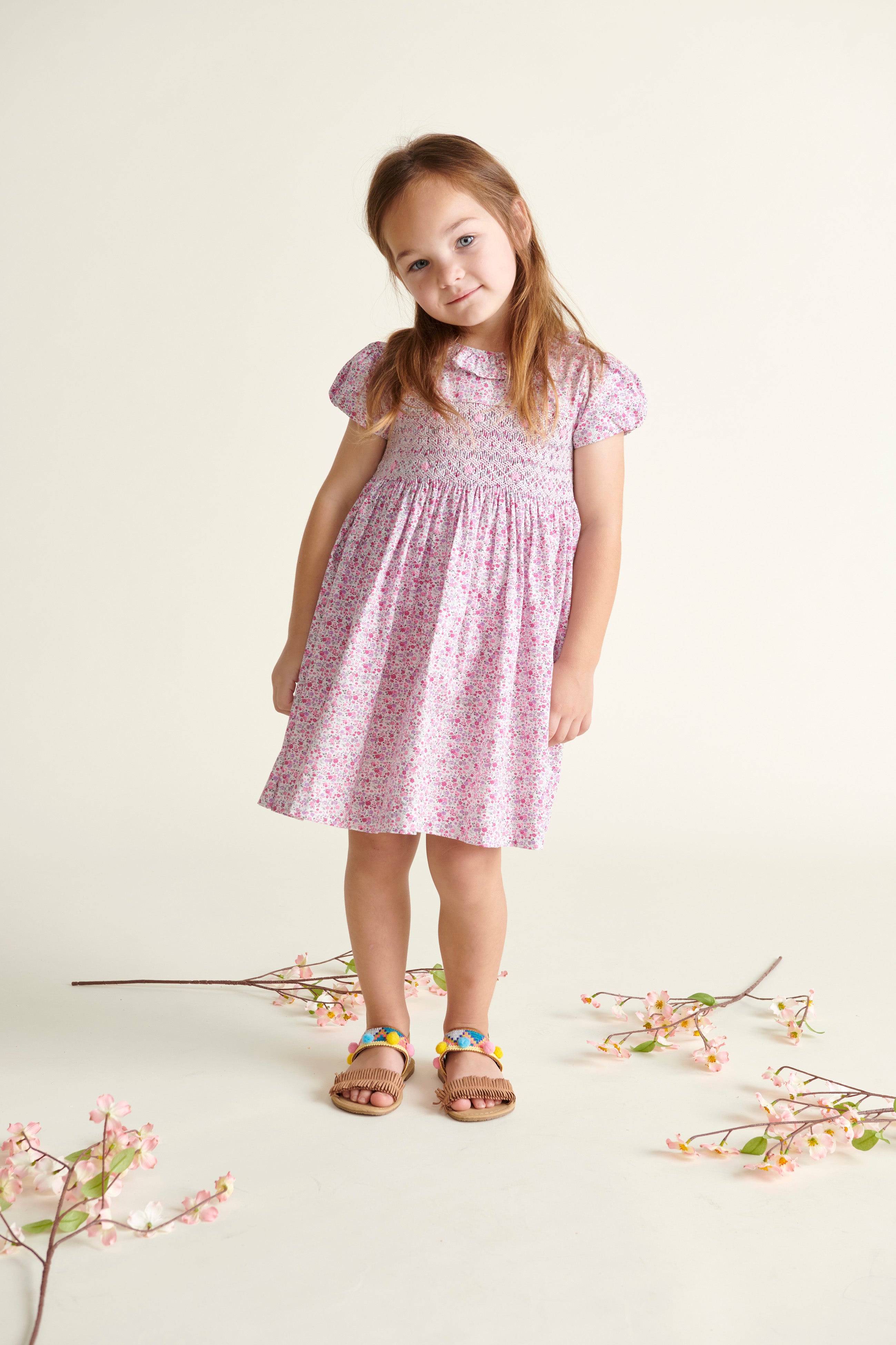 gril in pink floral dress with frill collar