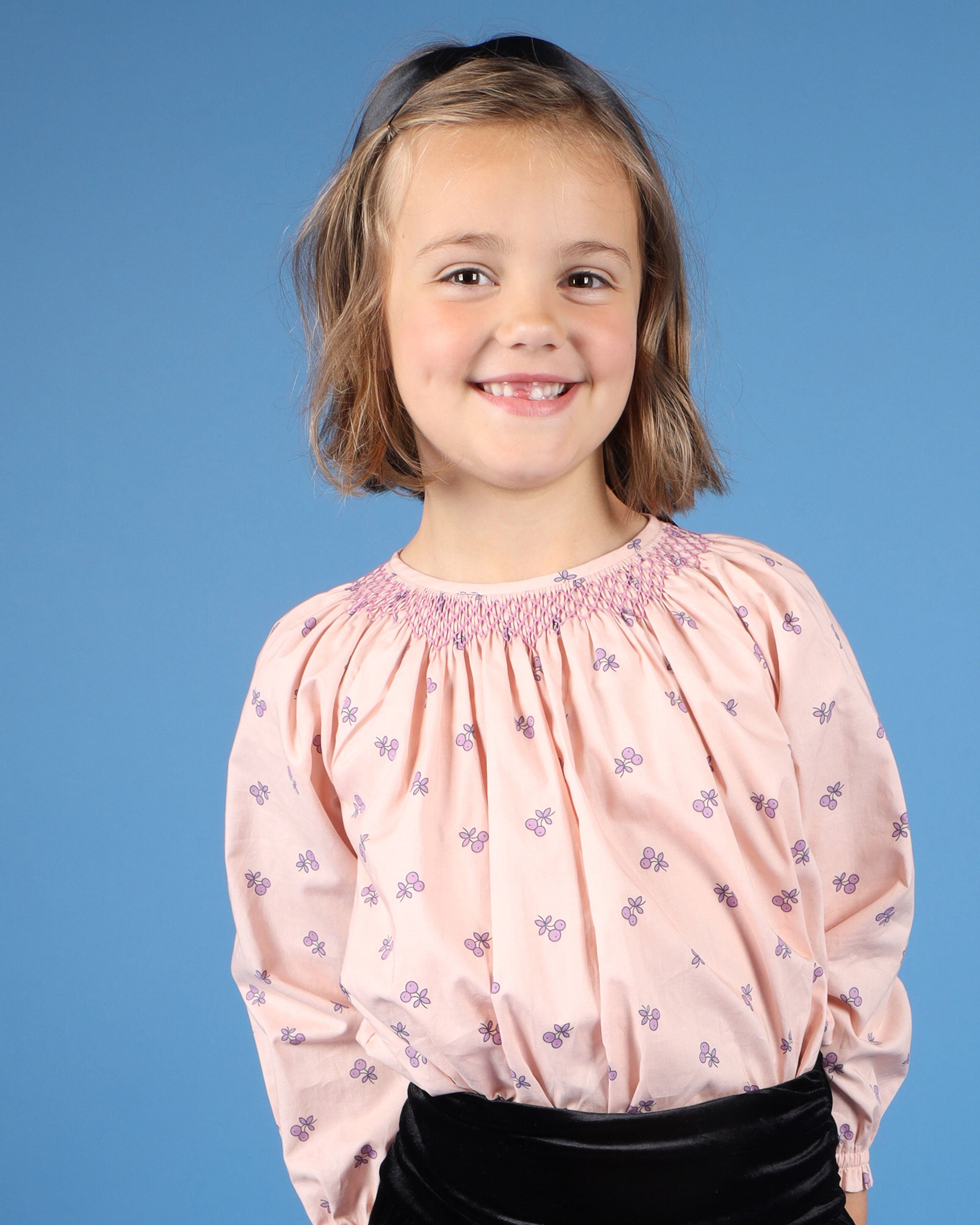 girl in hand-smocked cherry print blouse