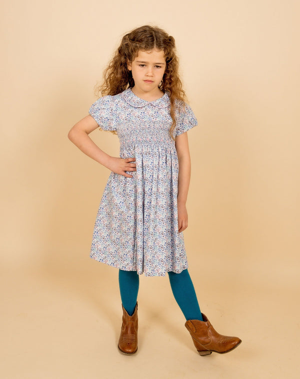 girl in smocked dress and cool cowboy boots