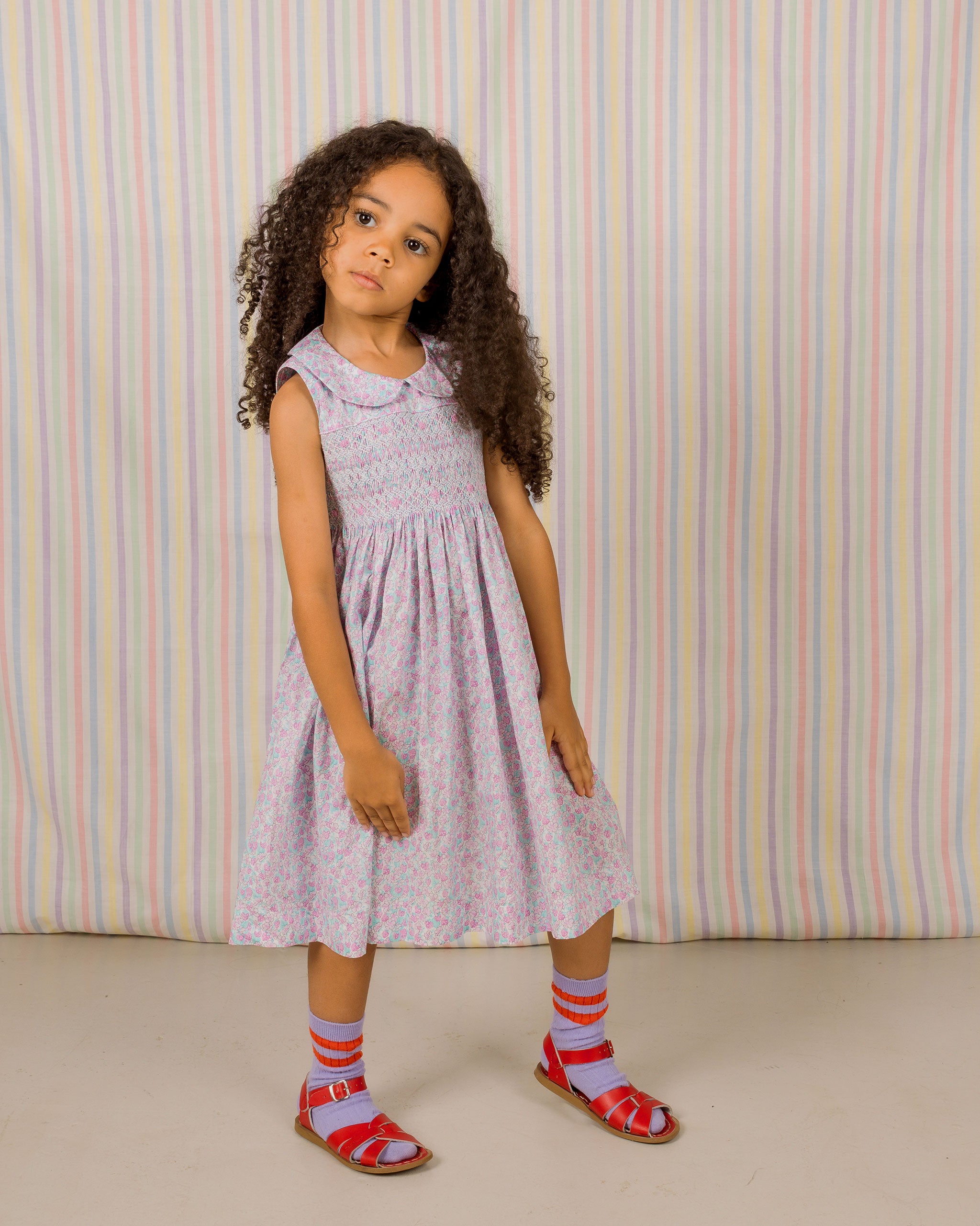 girl model in pink strawberry and blossom print smock dress