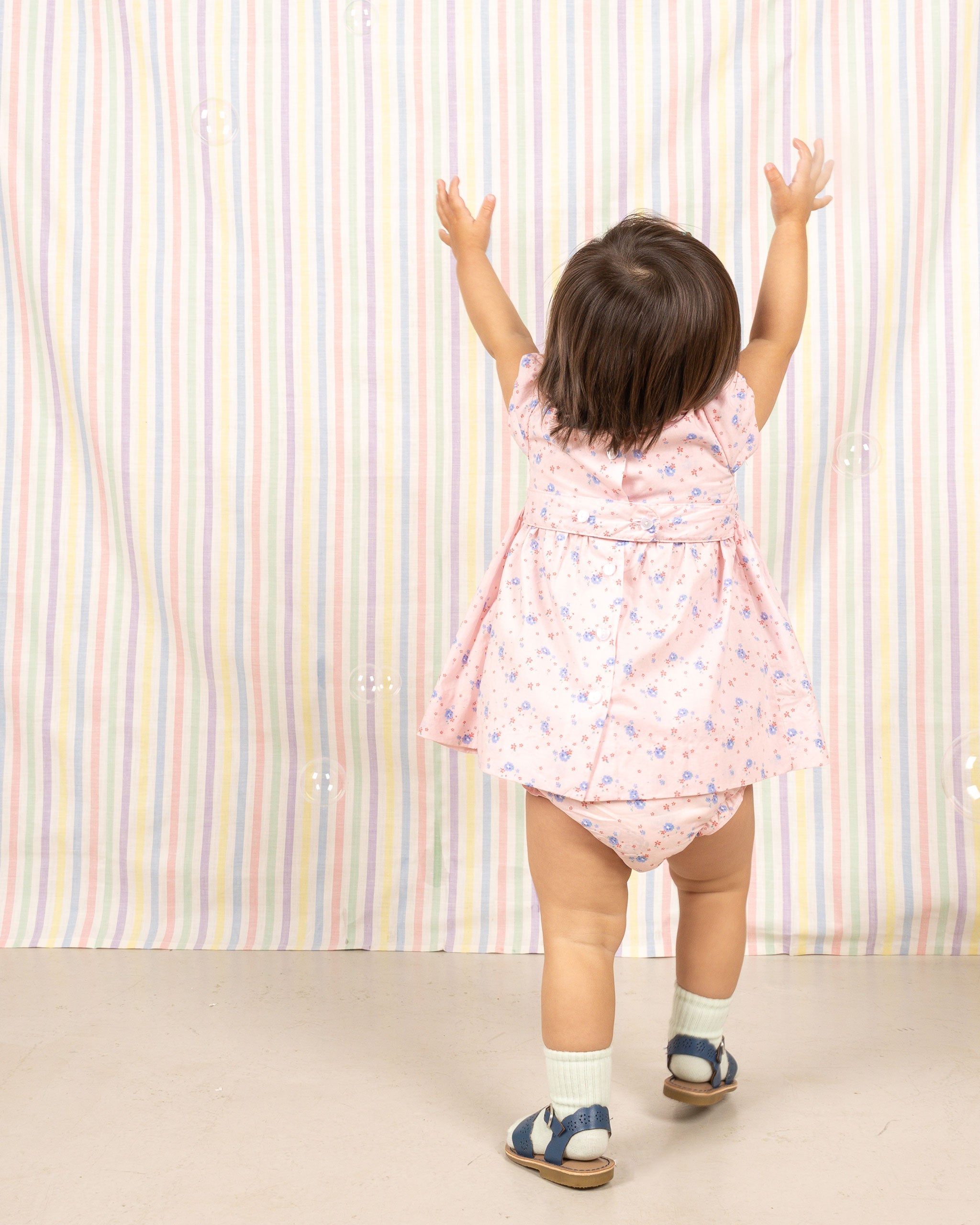 baby in pink dress, back view