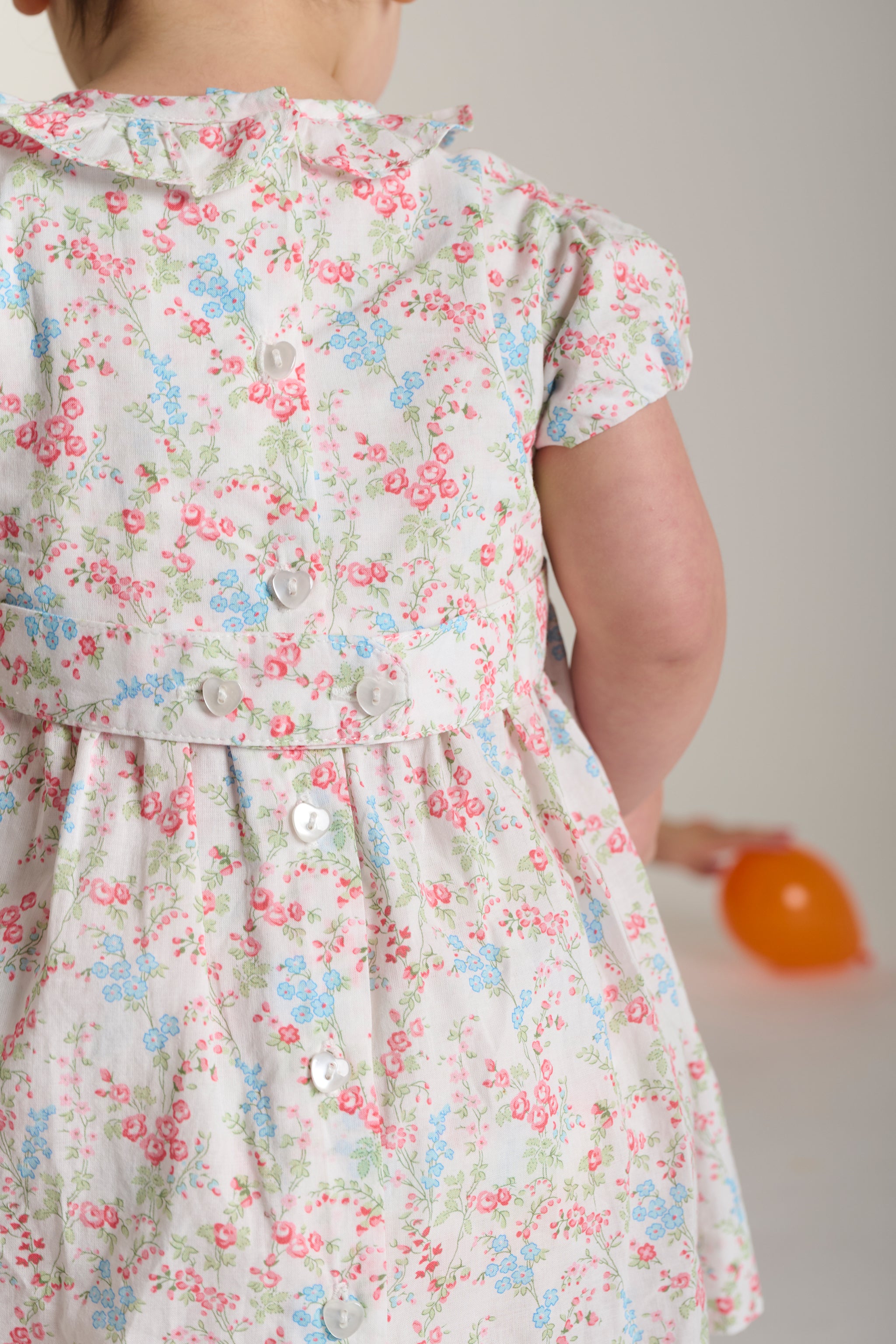 back off floral dress featuring heart buttons