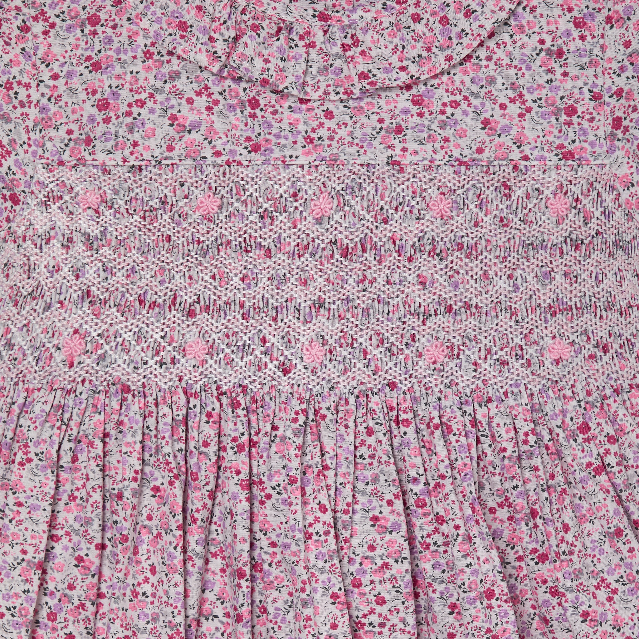 pink floral girls dress with hand-smocking, closeup