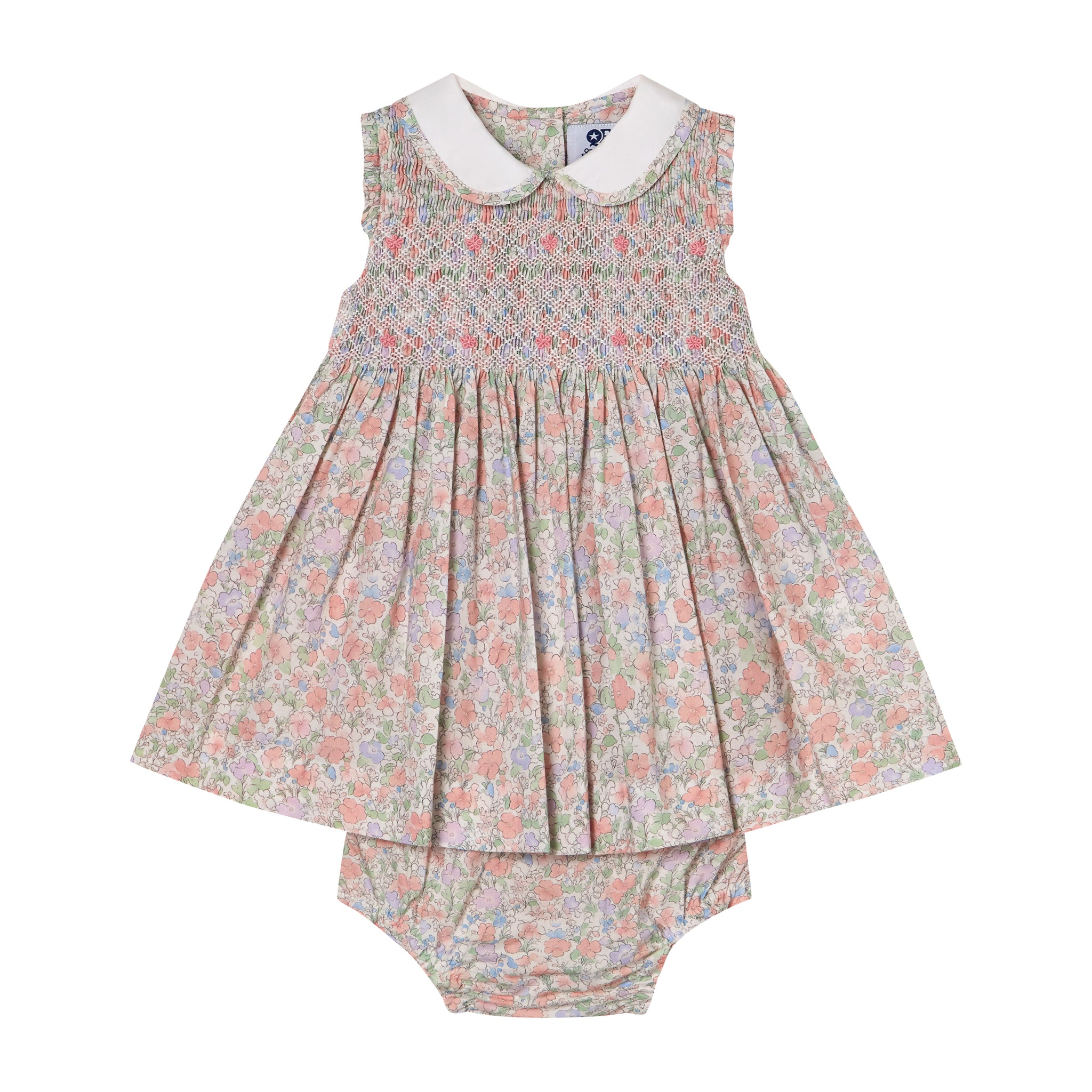 Floral hand-smocked baby dress and bloomers set on a white background