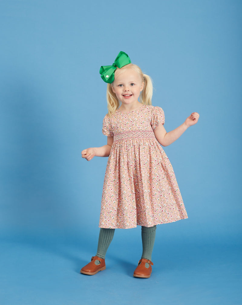 girl in pink smocked dress, floral fabric