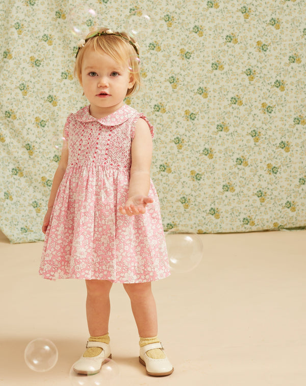 baby in Liberty print dress, pink, floral
