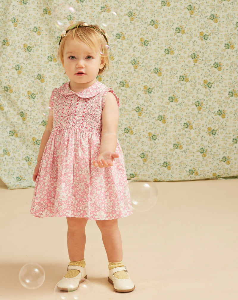 baby in Liberty print dress, pink, floral