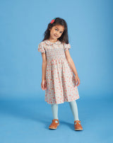 girl in floral smock dress made from Liberty fabric
