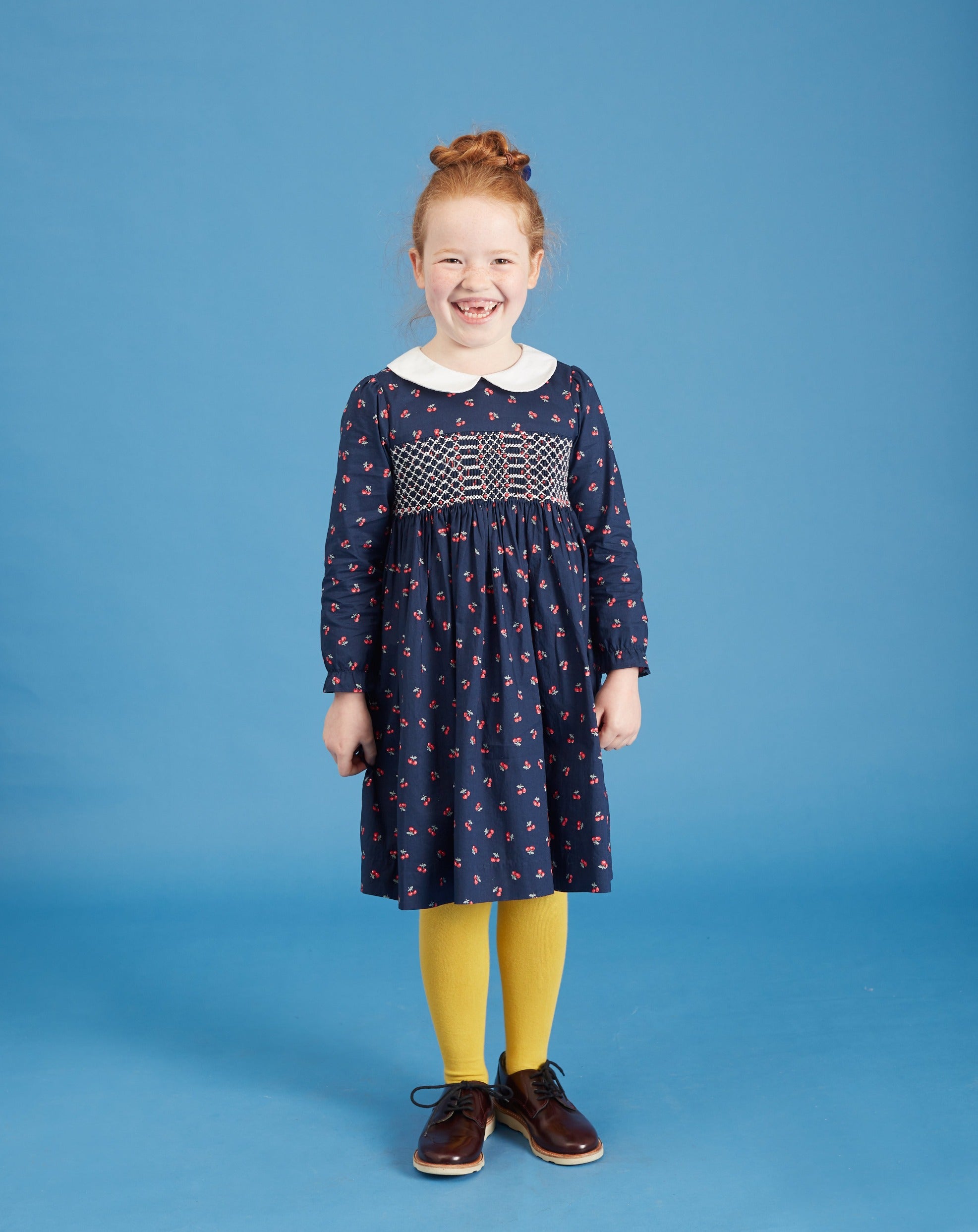 girl in smocked dress, navy with white collar