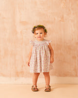 toddler wearing floral frill dress