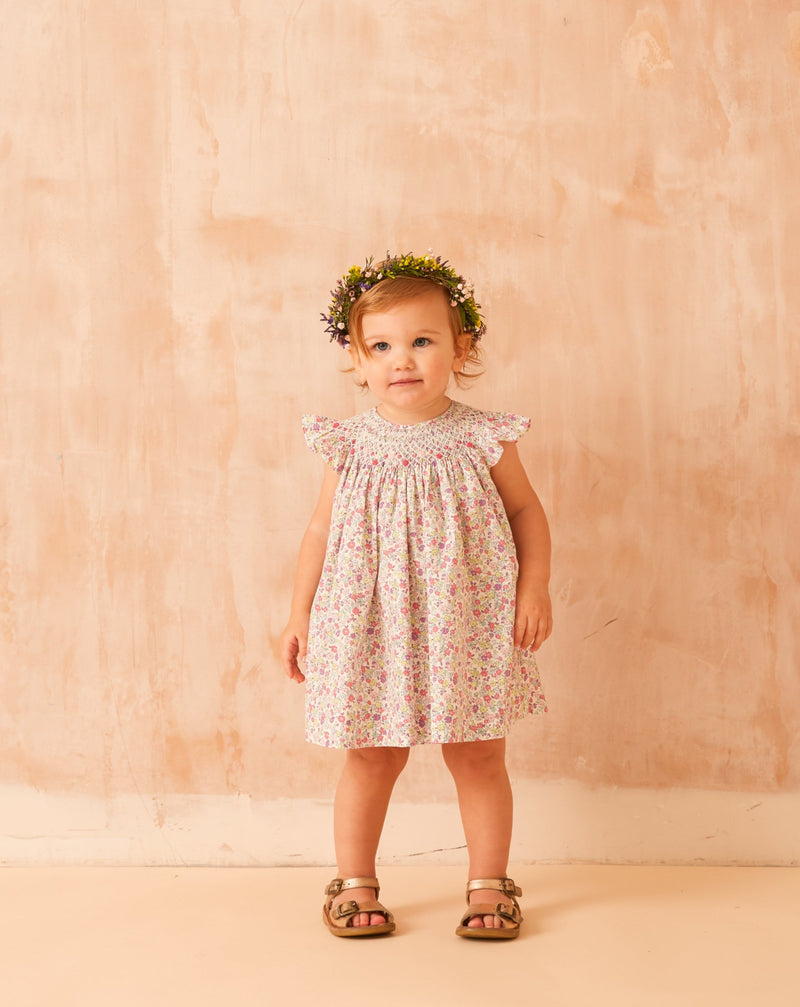 toddler wearing floral frill dress