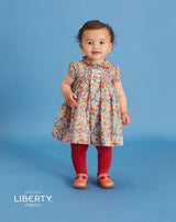 baby in Liberty hand-smocked dress