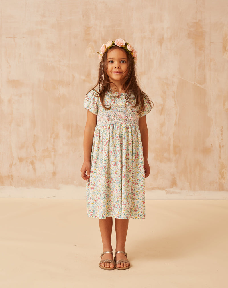 girl model wearing floral smock dress made from cotton