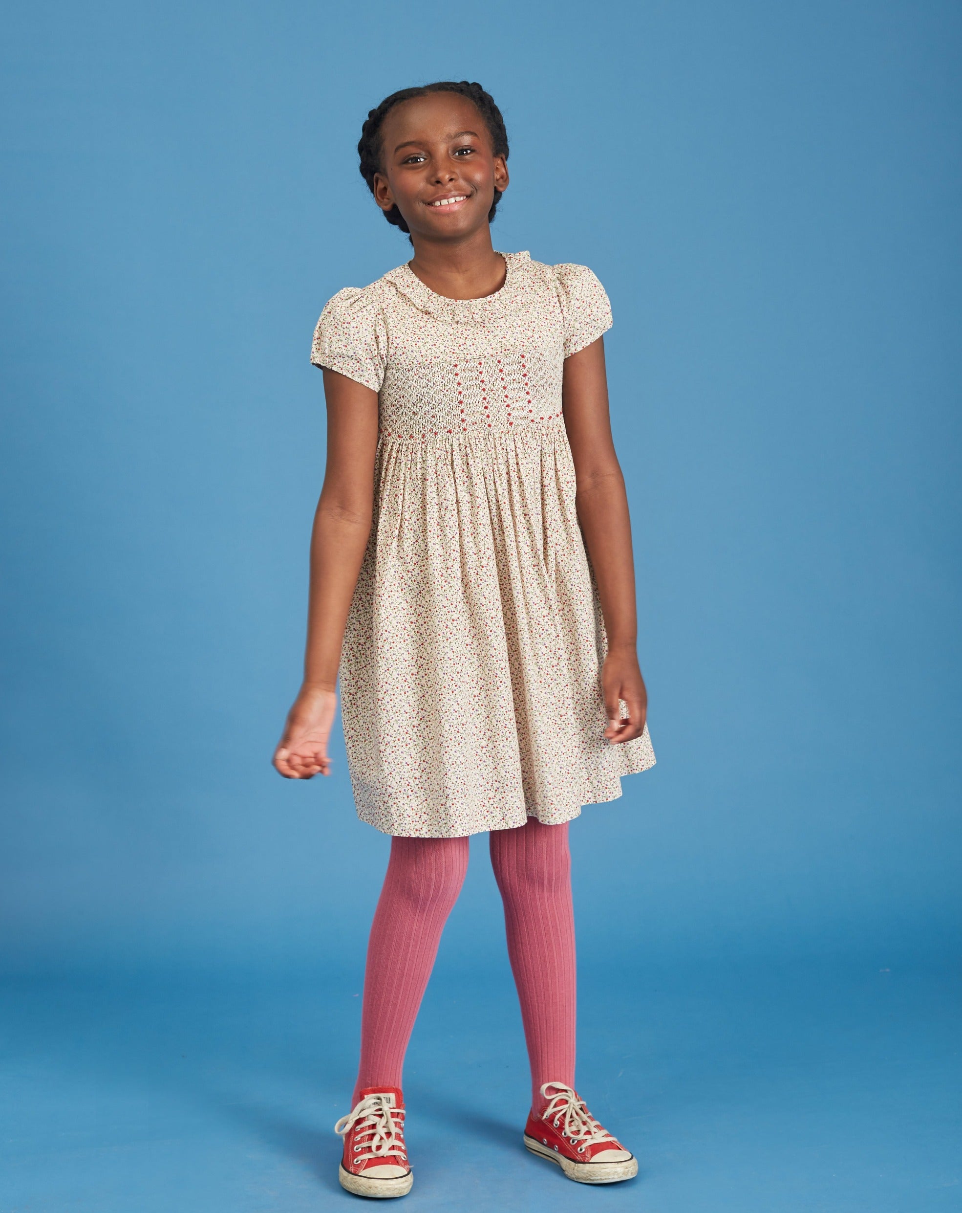 girl wearing cream colored smocked dress