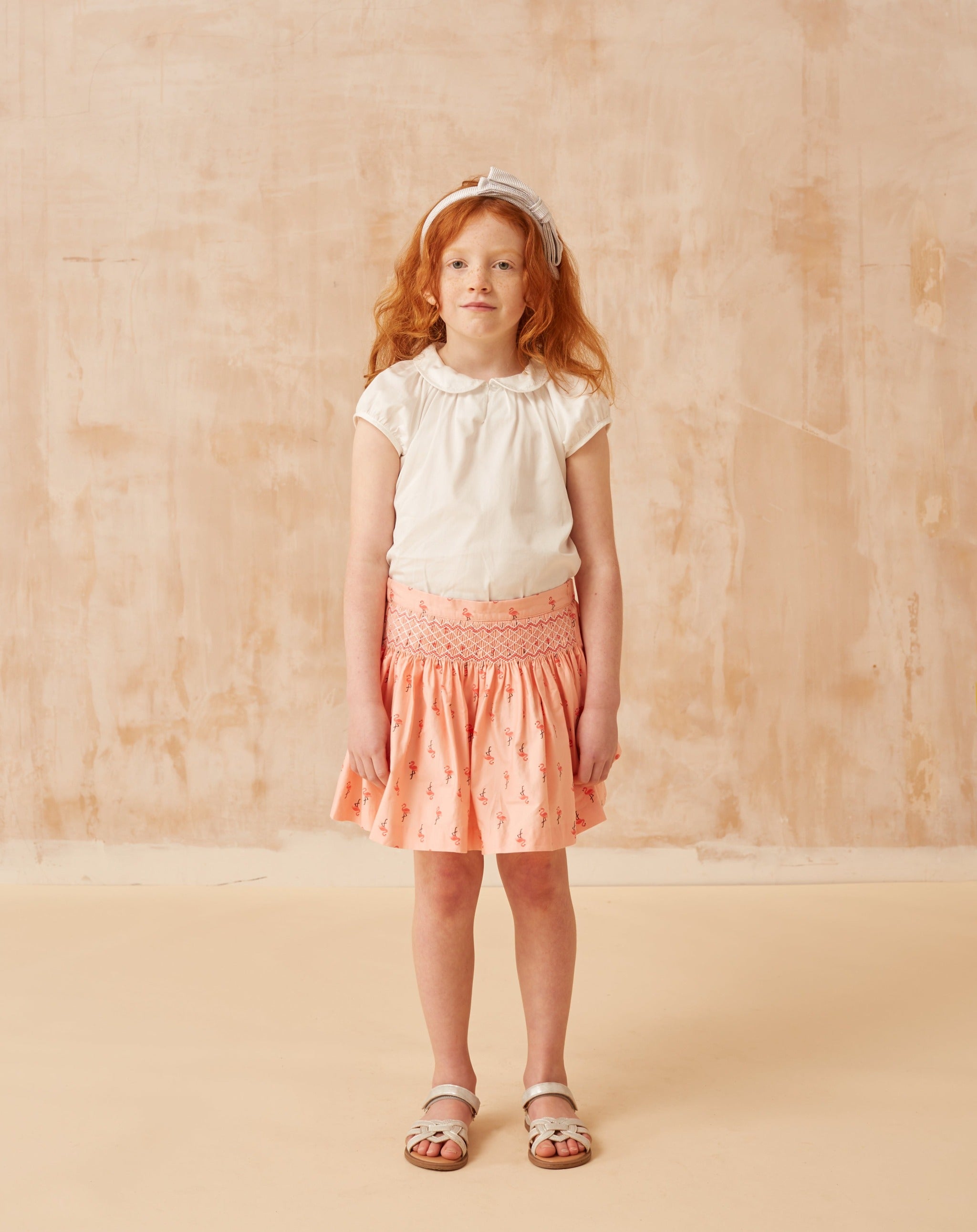 girl in flamingo skirt with smocking detail