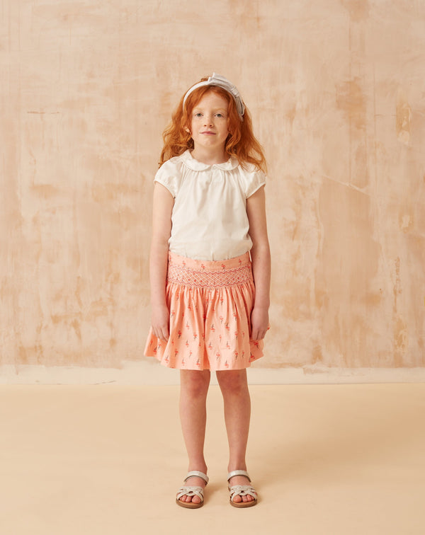girl in flamingo skirt with smocking detail